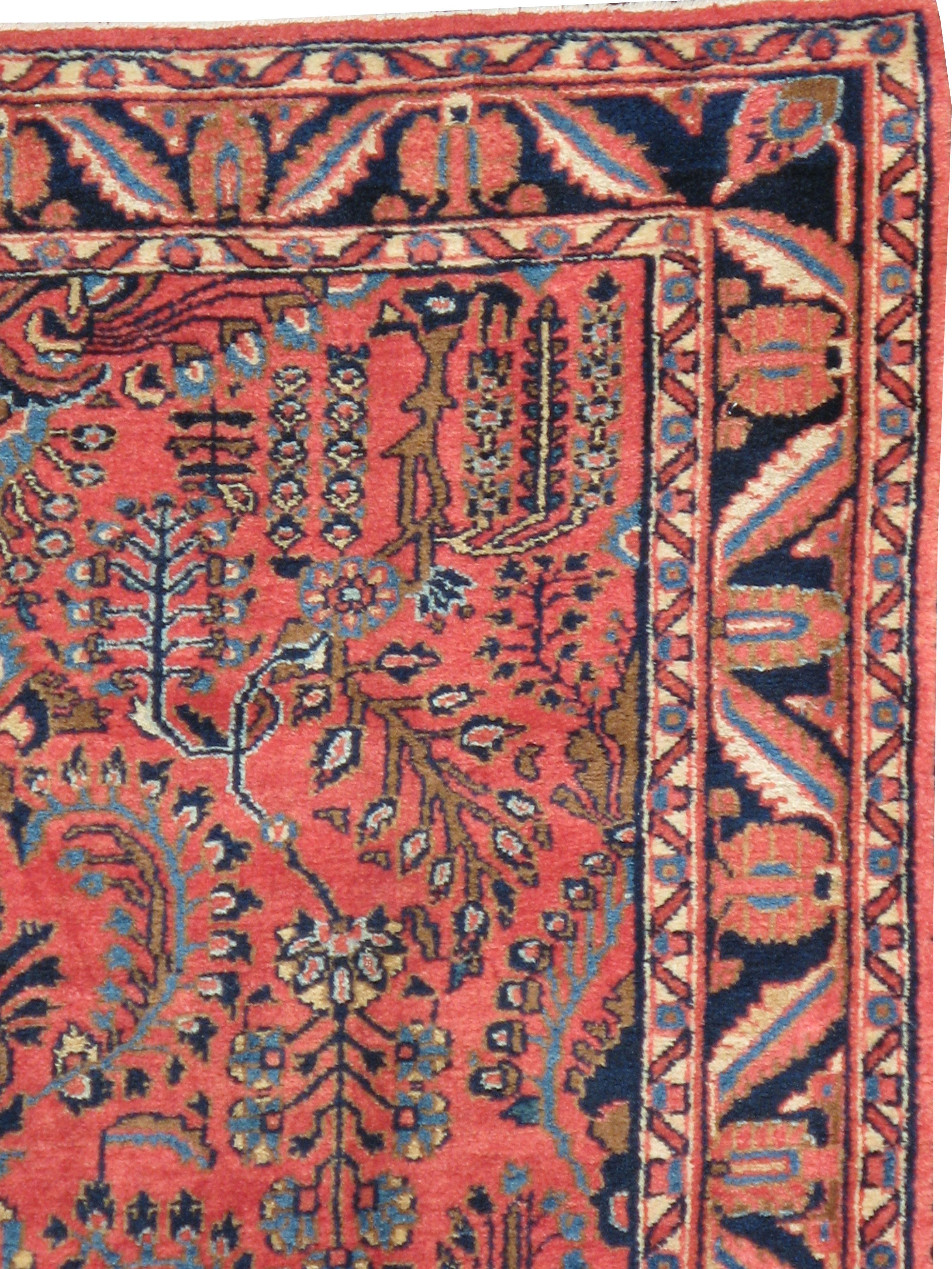 An antique Persian Sarouk Mohajeran rug from the early 20th century.