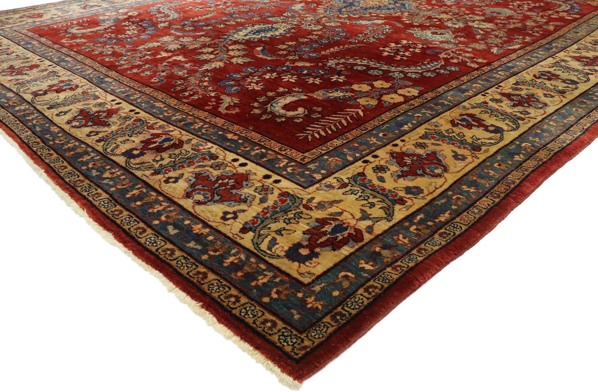 77516, antique Persian Mohajeran Sarouk rug with Jacobean style. Vibrant colors with beguiling ambiance, this hand knotted wool antique Persian Mohajeran Sarouk rug is poised to impress. The abrashed dark ruby red field is covered in an all-over