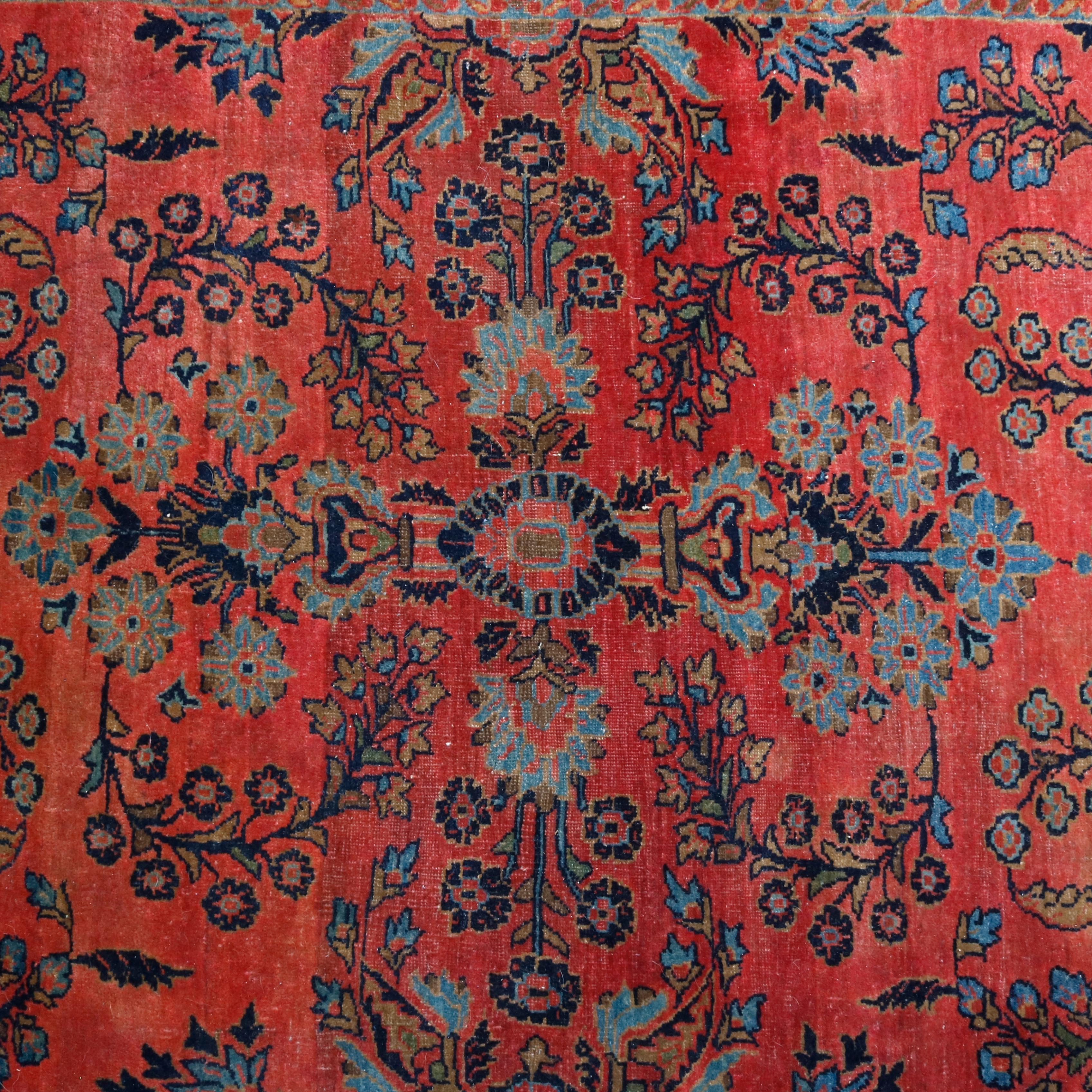 An antique Persian Sarouk offers wool construction with detached floral spray on red ground, circa 1920

Measures: 77