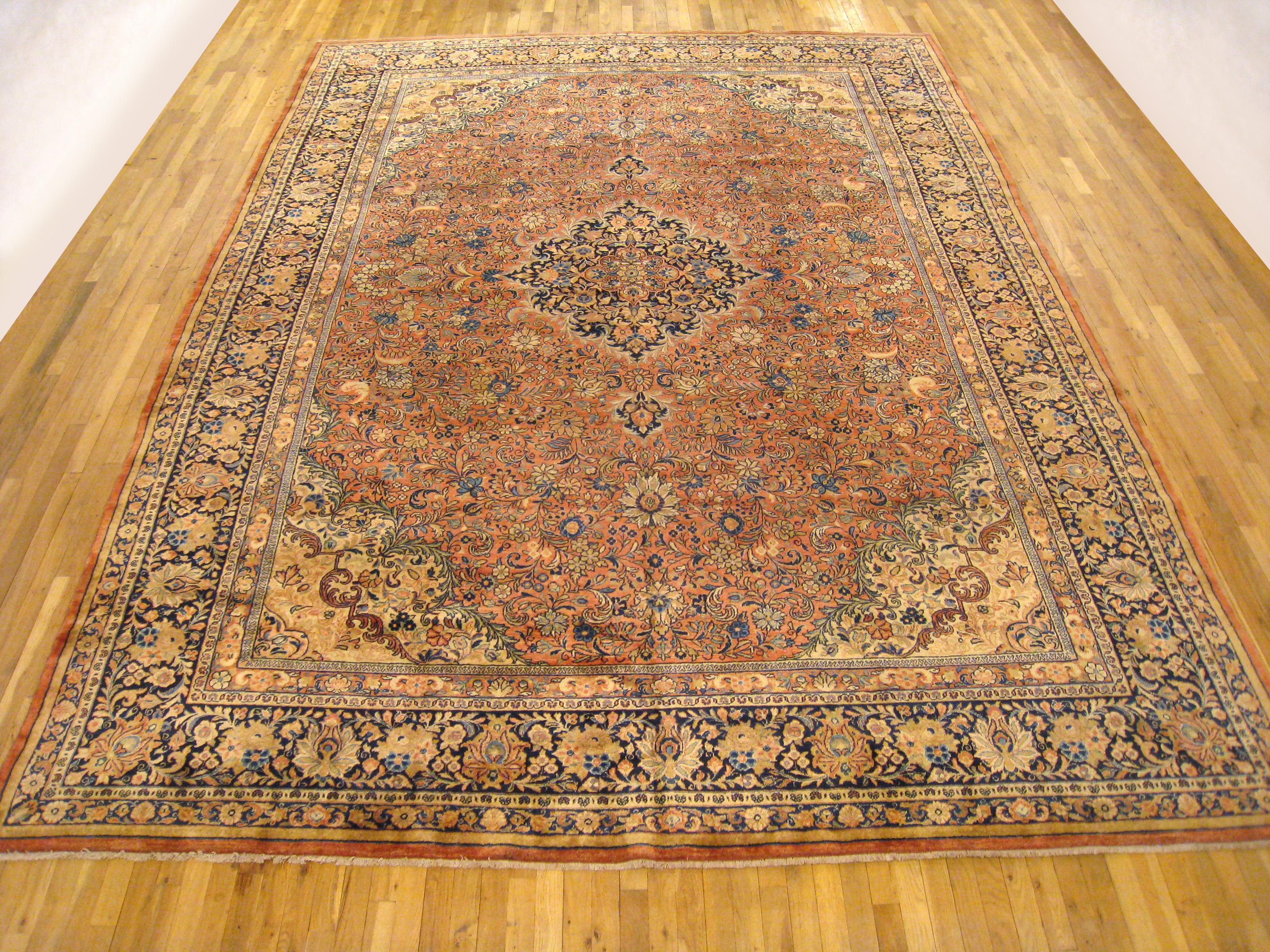 Antique Persian Sarouk oriental rug, circa 1920, room size.

An antique Persian Sarouk oriental rug, size 13'8