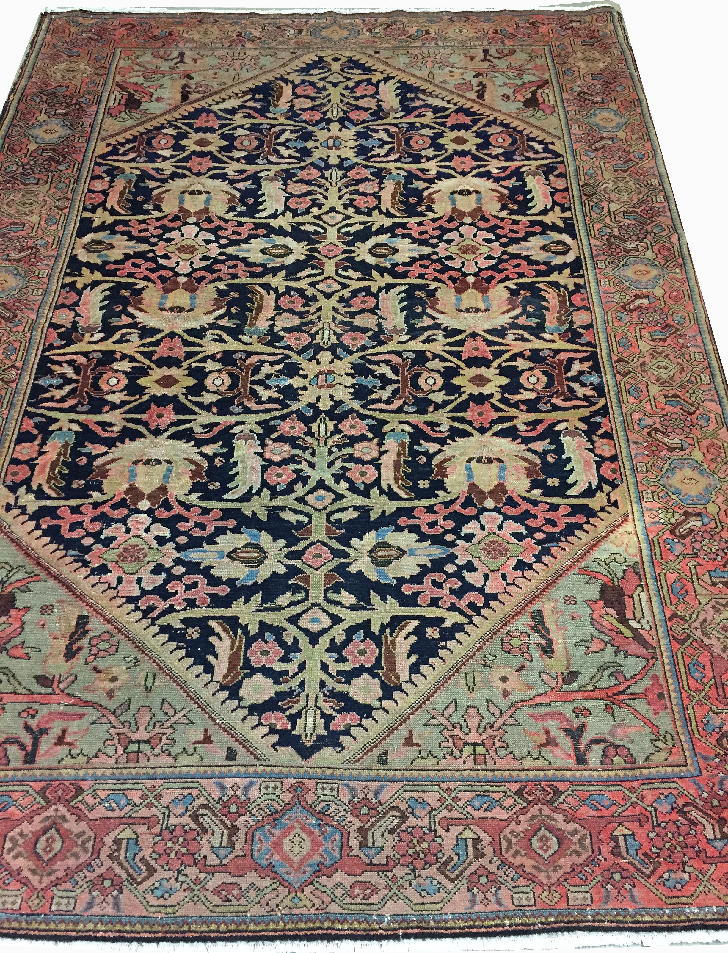 Antique Persian Sarouk rug, 4'6 x 7'7. A lovely Sarouk rug from Persia, circa 1900. The navy blue ground has wonderfully detailed floral and vine designs that show the true craftsmanship of Fine weaving at its best. The soft borders and four