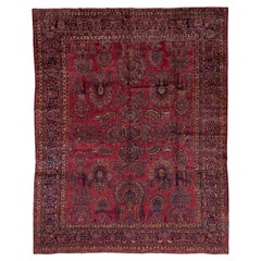 Tapis persan ancien Sarouk, champ rouge vif, touches d'or et de bleu, poils moyens