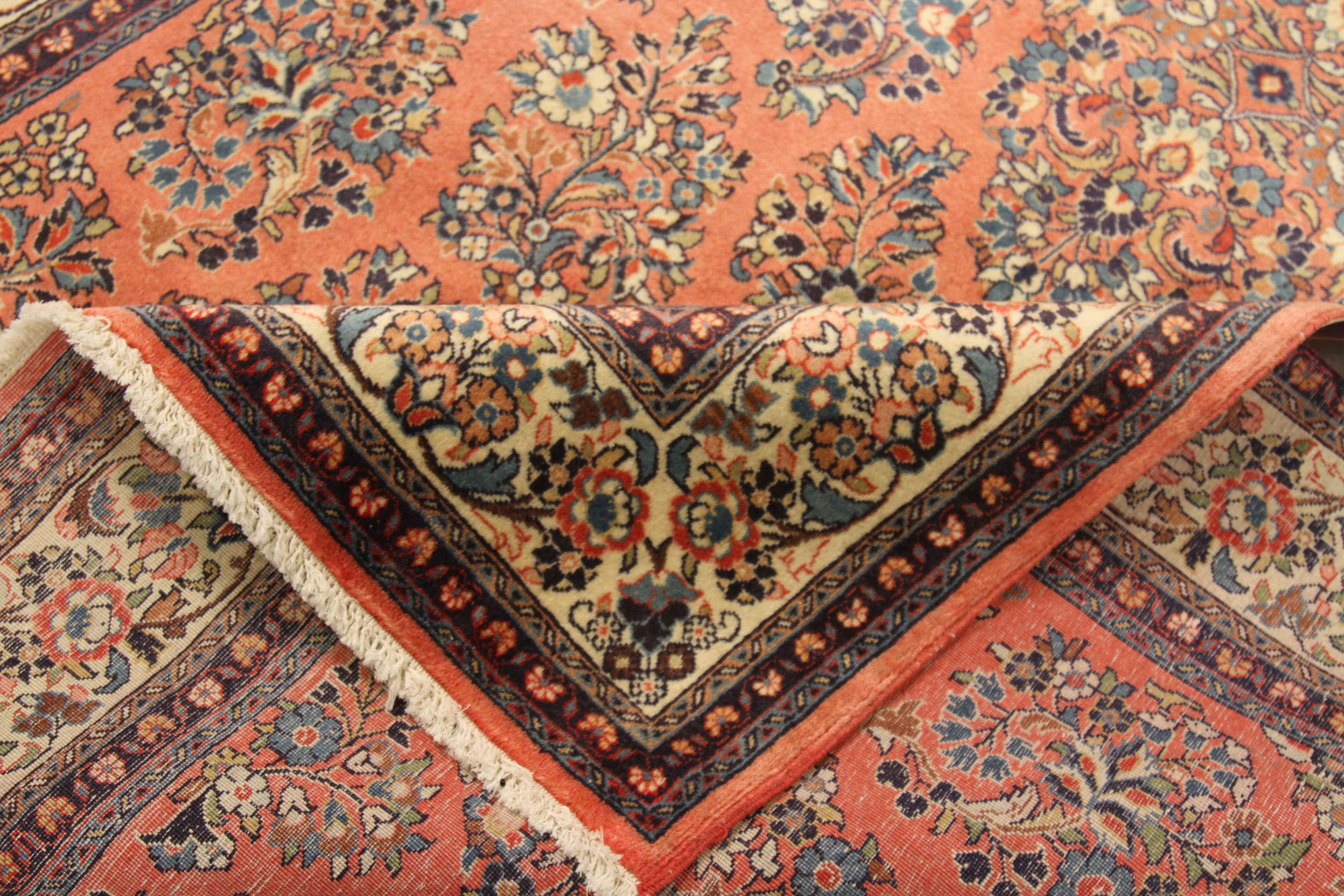 Antique Persian rug handwoven from the finest sheep’s wool and colored with all-natural vegetable dyes that are safe for humans and pets. It’s a traditional Sarouk design featuring flower heads using a lovely mix of blue and ivory. It has a red