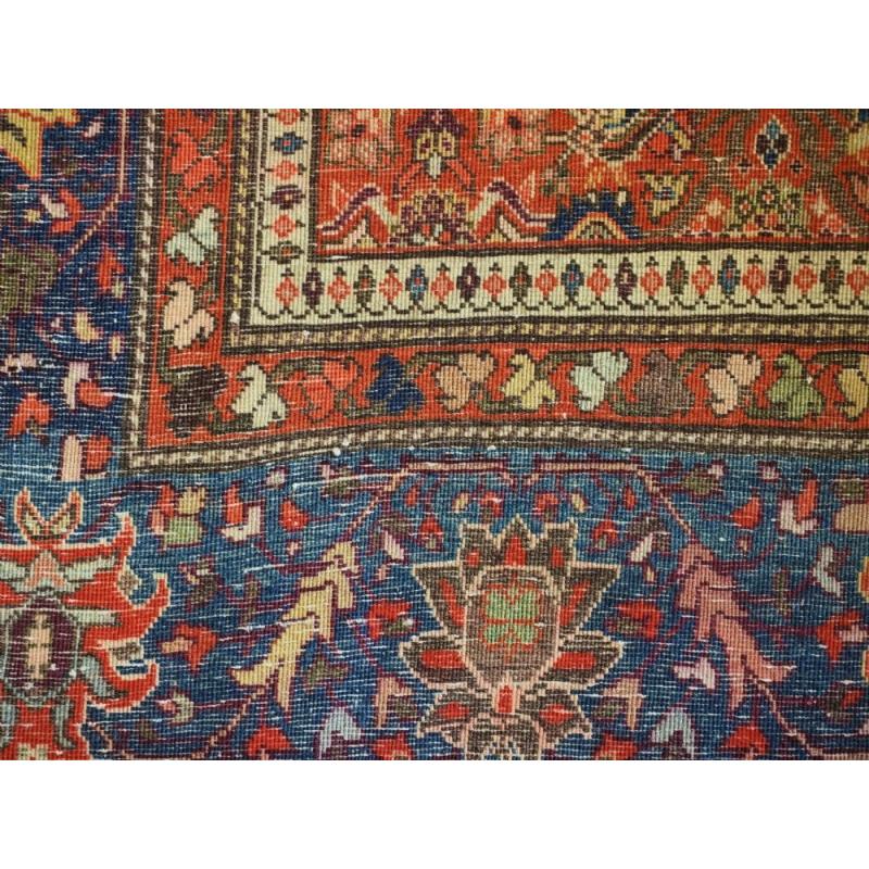 Antique Persian Sarouk rug of boteh design with a soft colour palette
Circa 1900-20

A very pleasing rug with rows of floral boteh set on an ivory ground, the corners are in herati design in a soft terracotta red The floral border in light indigo