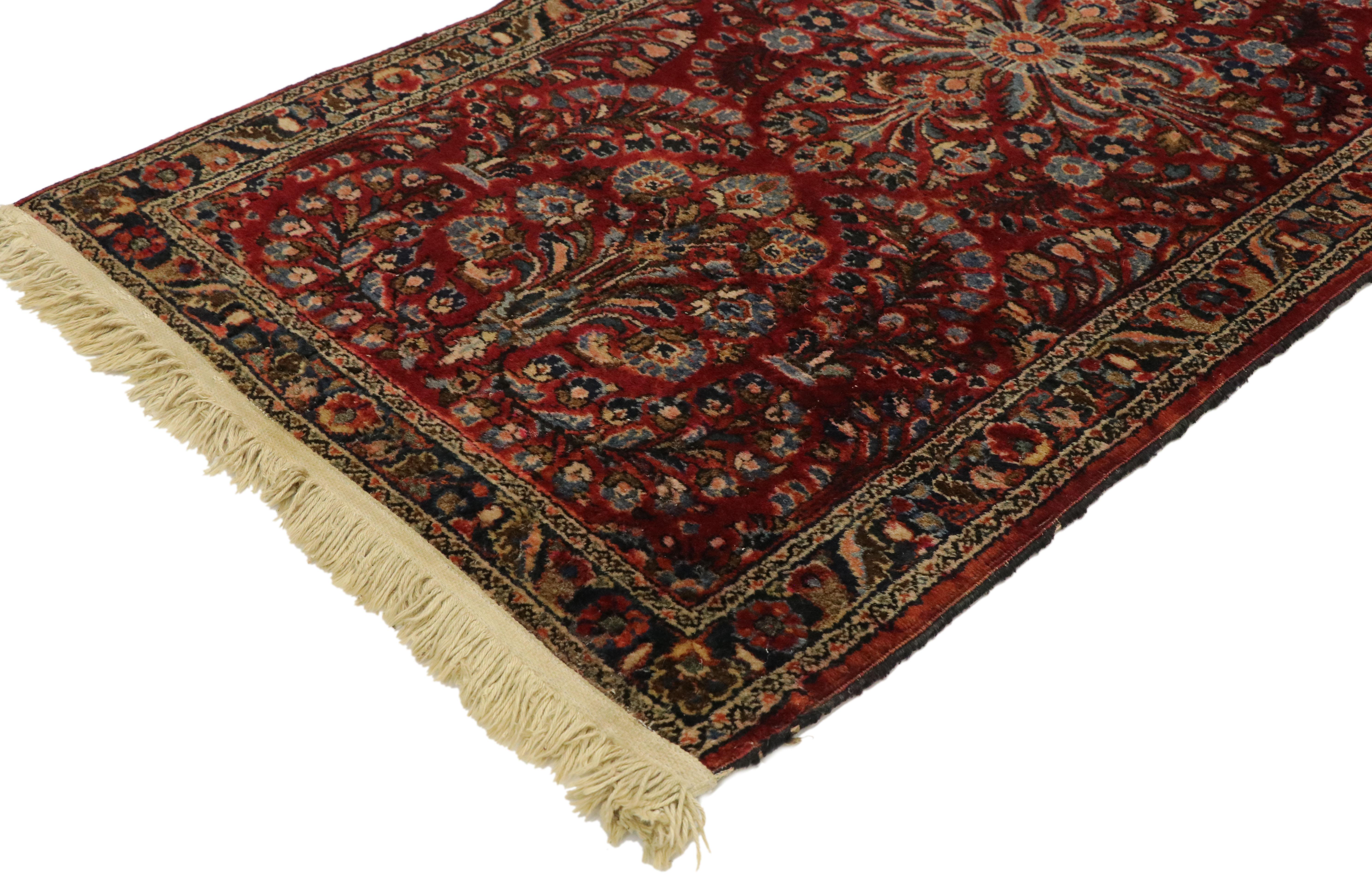 This highly desirable antique Persian Sarouk rug features an all-over floral with a refined palette illuminating its lively, composition. The charmingly all-over pattern of striking palmettes and botanical motifs embellished with serrated details