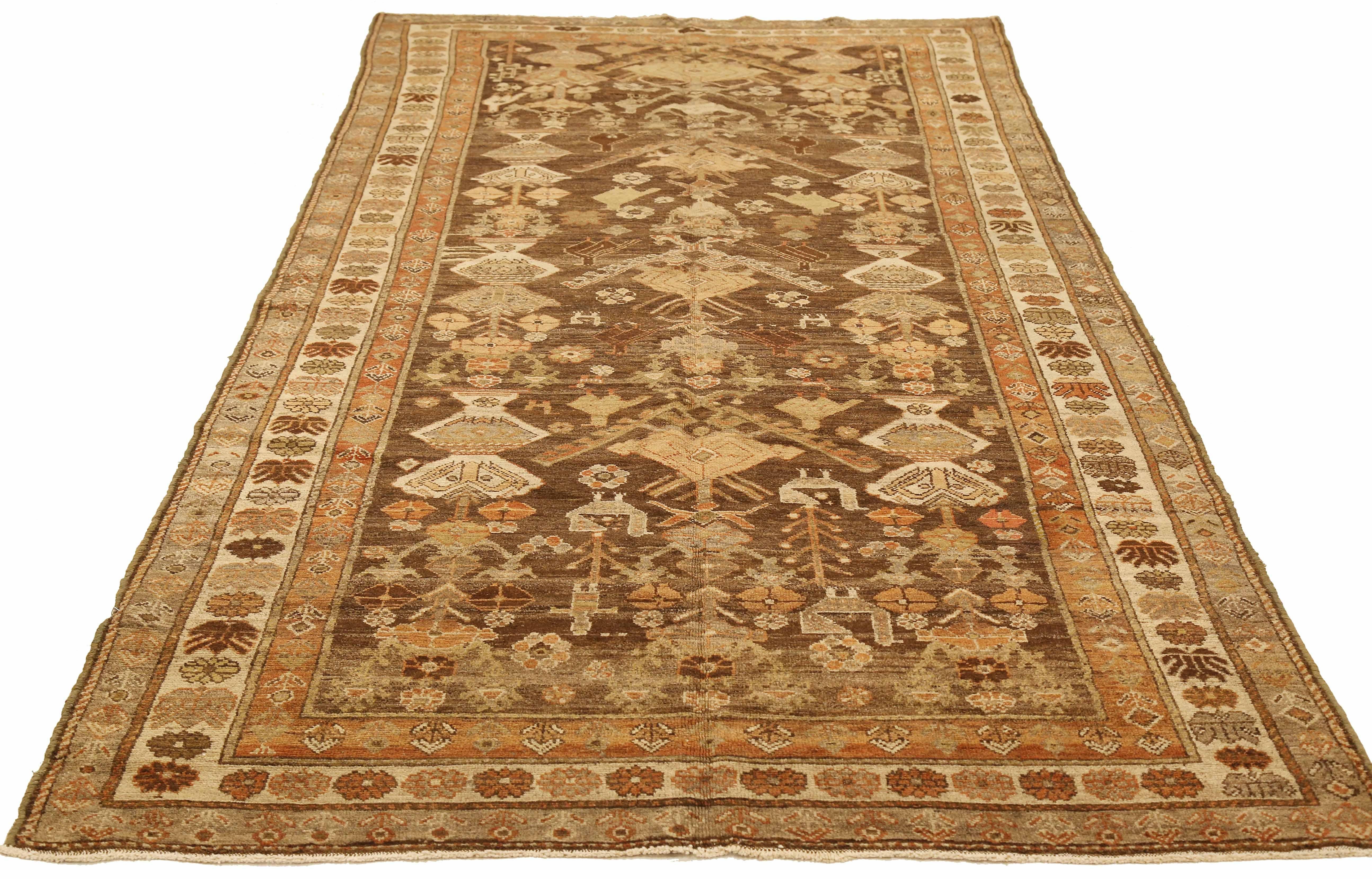 Antique Persian rug handwoven from the finest sheep’s wool and colored with all-natural vegetable dyes that are safe for humans and pets. It’s a traditional Saveh design highlighted by brown and ivory floral patterns. It’s a beautiful piece for