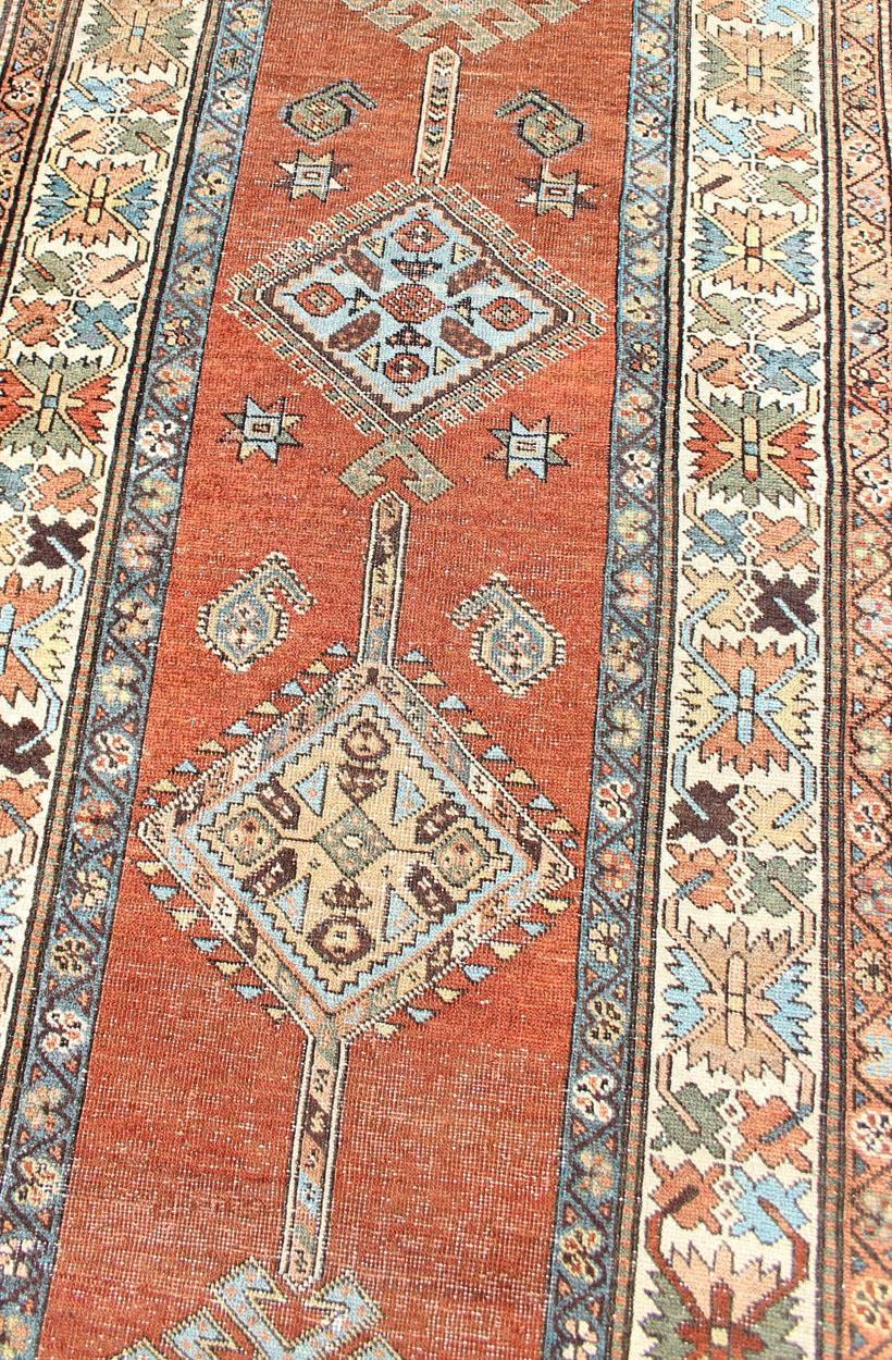 20th Century Antique Persian Searpi Runner with Geometric Medallions in Orange, Blue, Ivory For Sale