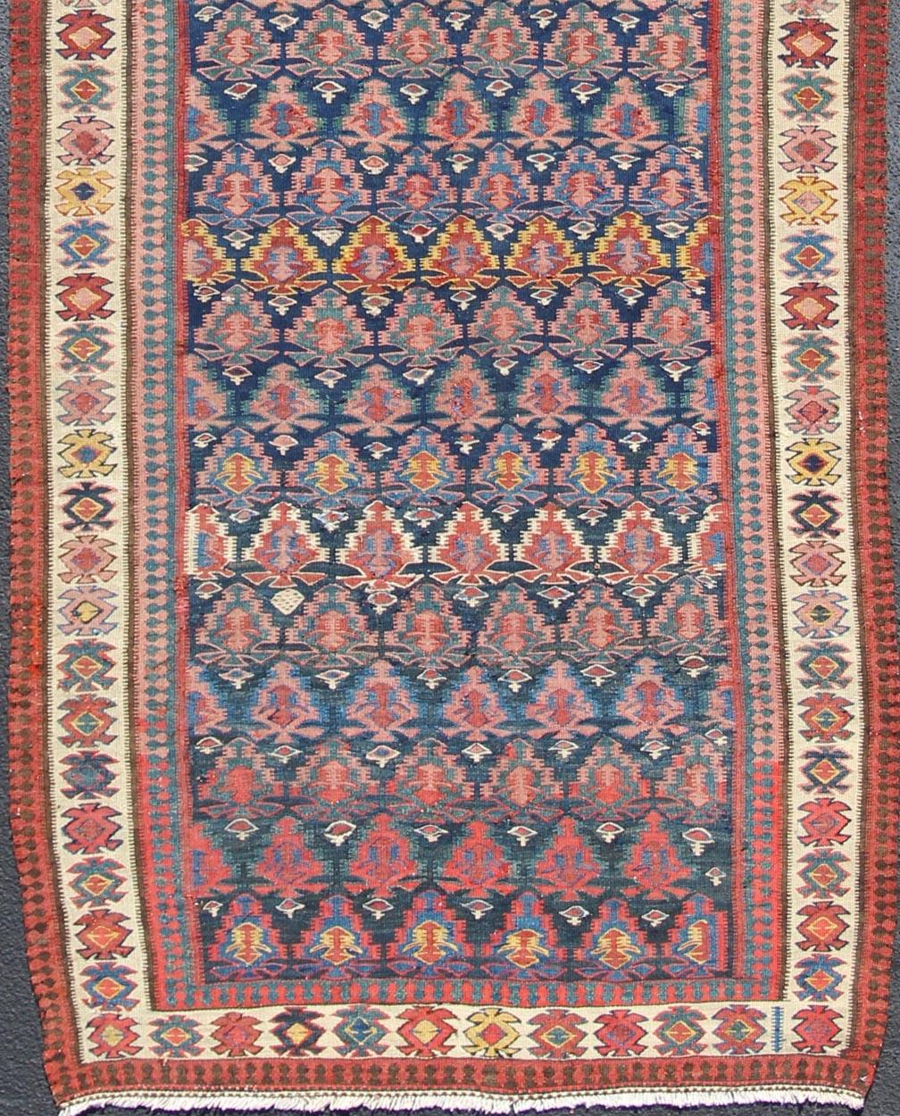 Vibrant runner with a beautiful blue color-toned, Geometric Design Kilim Runner antique Kilim Gallery from Persia, rug 19-0805, country of origin / type: Iran / Kilim, circa 1900

Featuring a Floral and paisley design, with complementary geometric