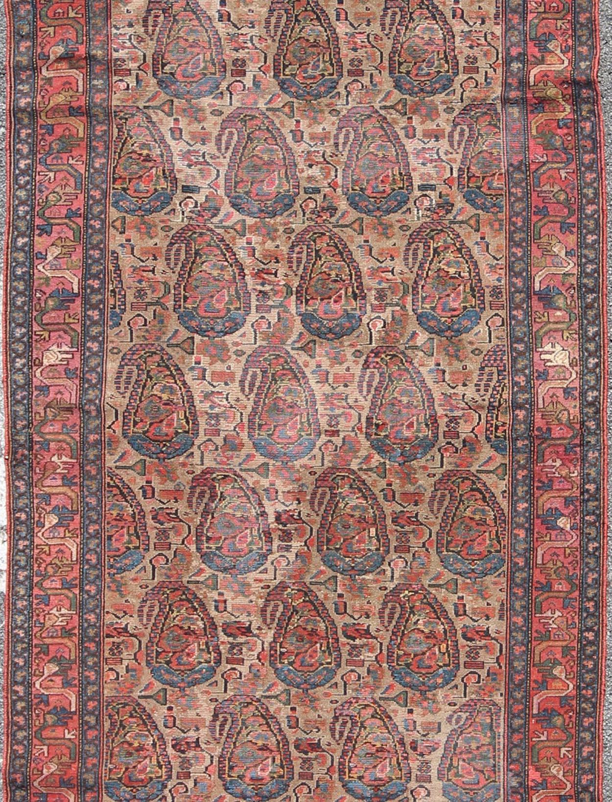 Measures 4'0 x 9'2

The richly intricate design of this handwoven, antique Seneh Malayer rug distinguishes it from all others of its kind. The iconic all-over design consists of paisley surrounded by curving leaves. A blend of Persian inspiration