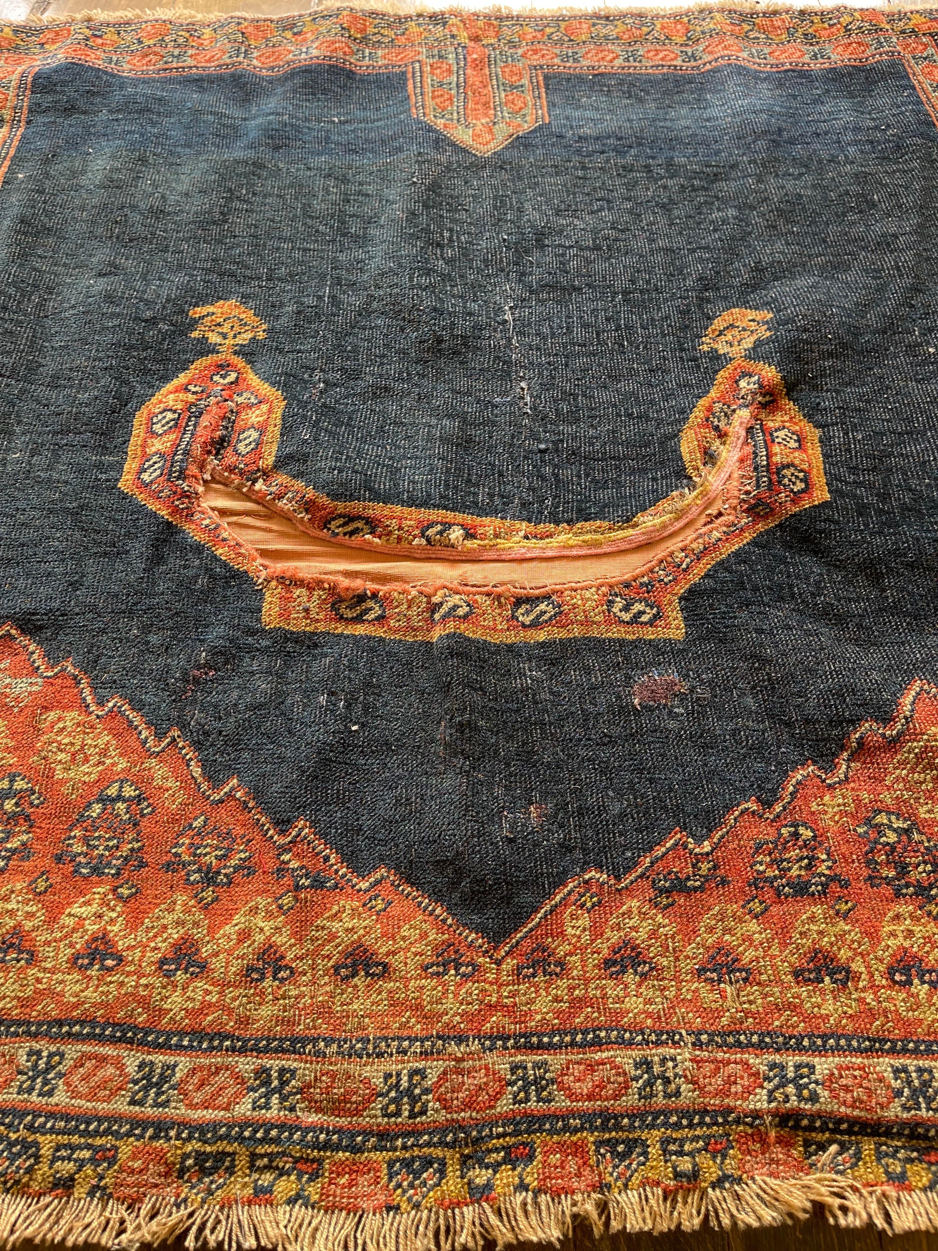 A beautiful and rare horse cover created in the town of Sanneh in Kurdistan region. The rug must have been woven by an artist/weaver as a gift to be taken to her home after she is married,a tribal tradition.The horse cover features a navy blue field