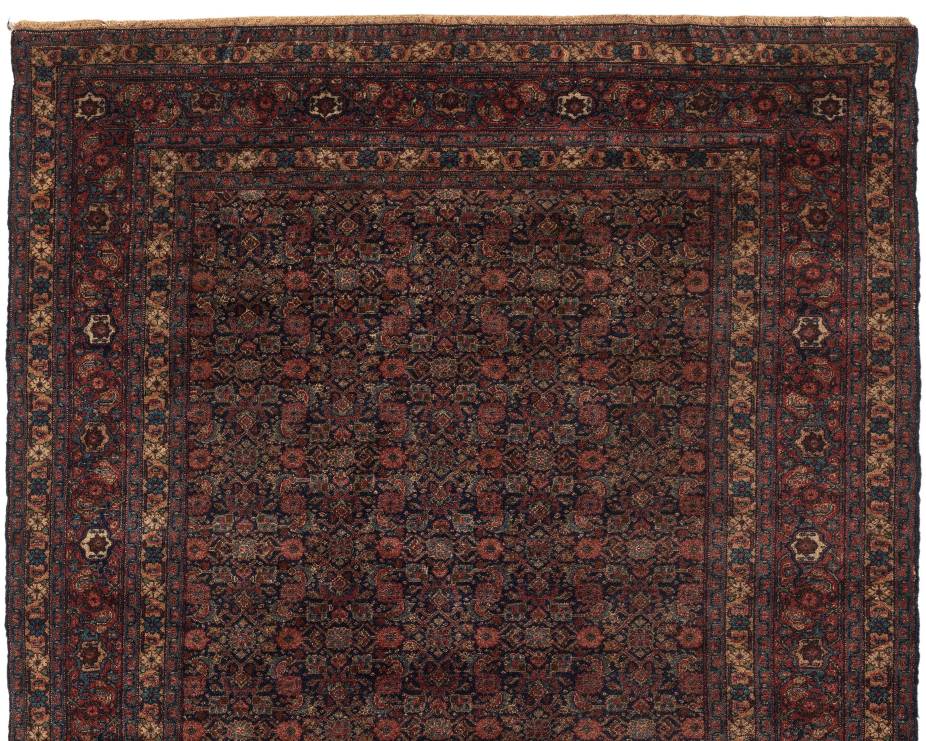 Antique Senneh rug, circa 1900. One of a matching pair. From the town of Senha (Sanandaj) in Kurdistan come antique rugs that attain nearly miraculous fineness and suppleness. And they are rugs, almost never room sizes or runners. The attention to