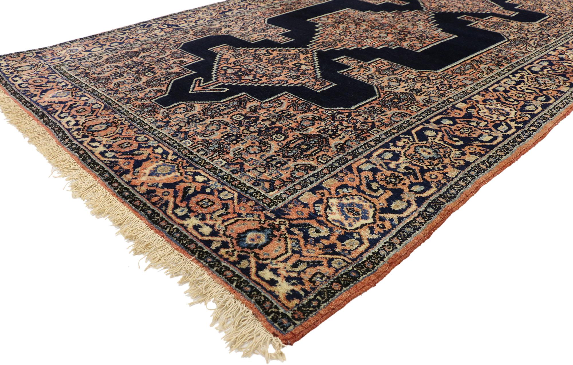 72547 Antique Persian Senneh Rug with Modern Style 04'04 X 06'09. This hand-knotted wool antique Persian Senneh rug with modern style features a triple stacked medallion in an open abrashed navy blue field surrounded by a complementary spandrel and