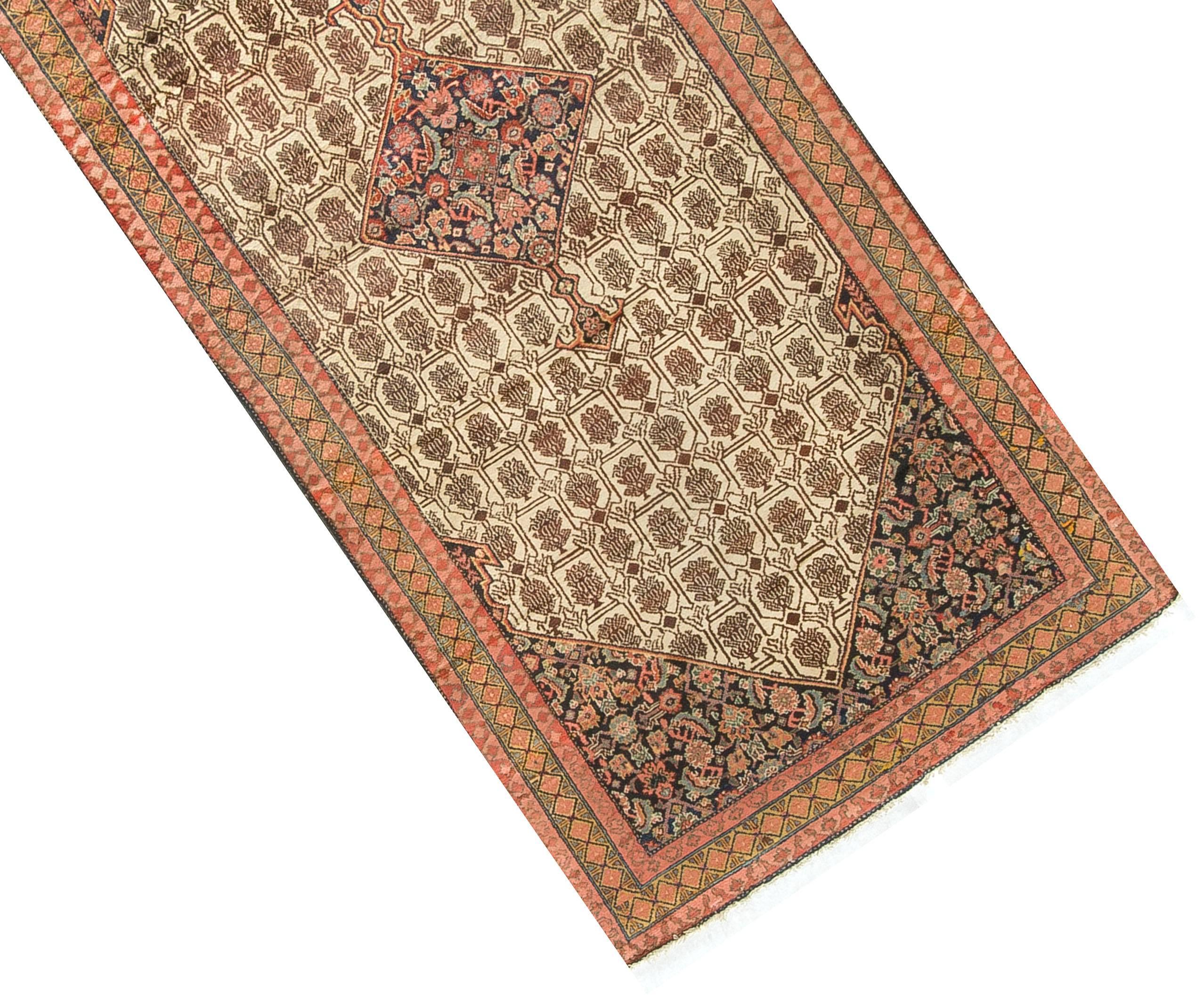 Antique Persian Serab Camel Hair Rug Runner circa 1900. A fine camelhair wool Serab rug, the central field in earth tones enclosing a central floral design medallion which is repeated in the four corner spandrels the wool used is quite often from