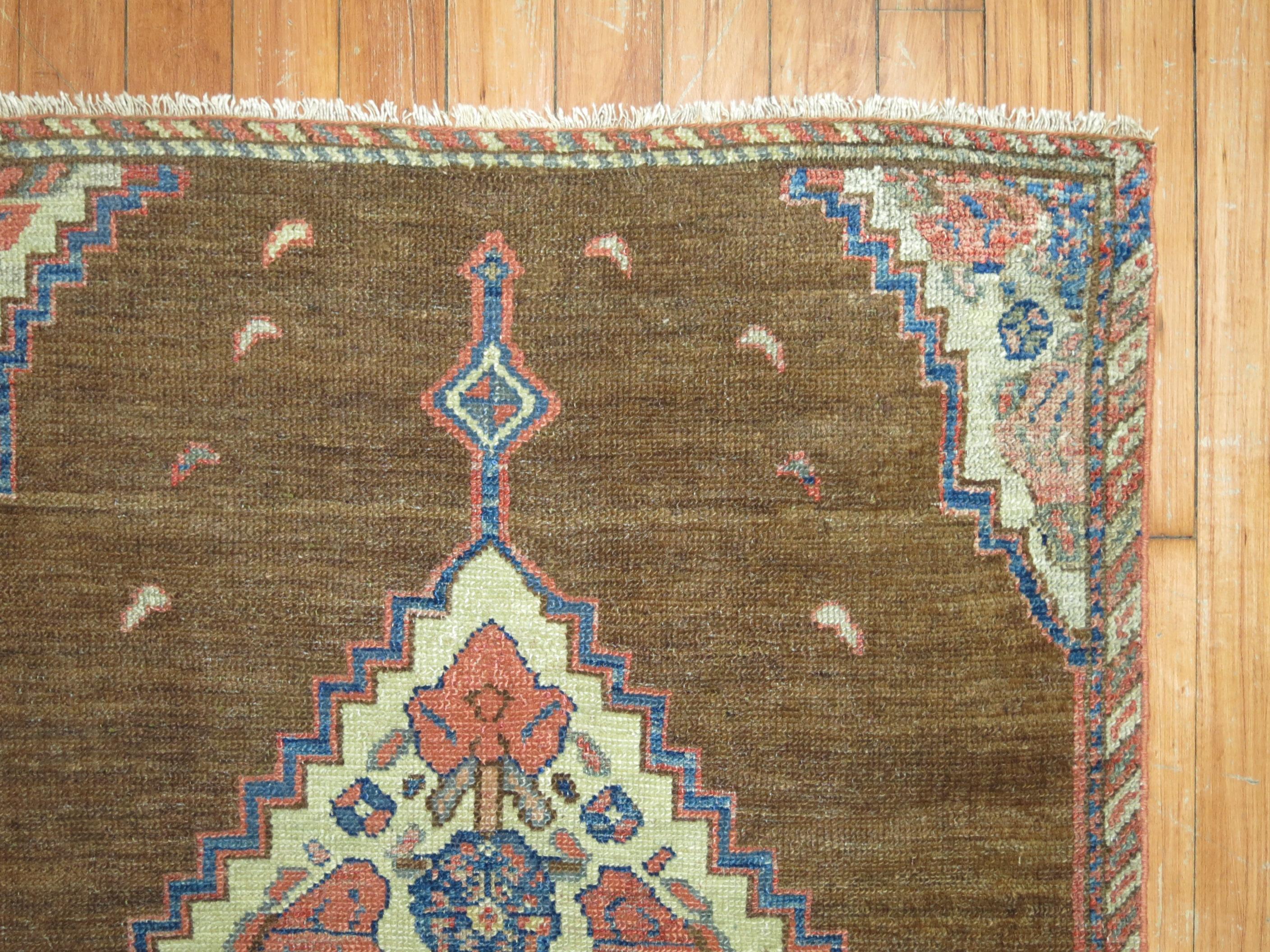 An early 20th century Persian Serab square size mat. Simple open design on a brown camel field.