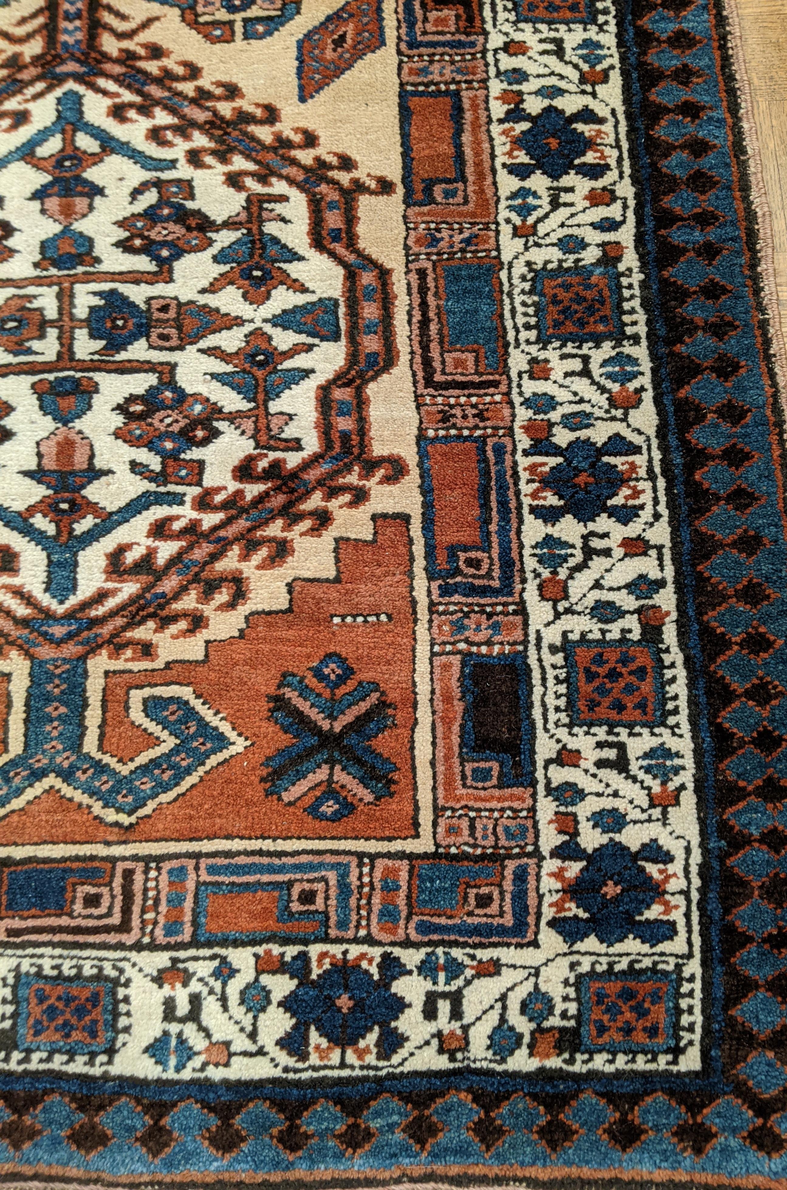 This is a striking antique Persian Serab. Serab rugs are known for their geometric design as well as the use of camel color. The typical Serab motif with the use of a cinnamon rust color is accented on the camel field. This rug is 3-1x6-10 and is