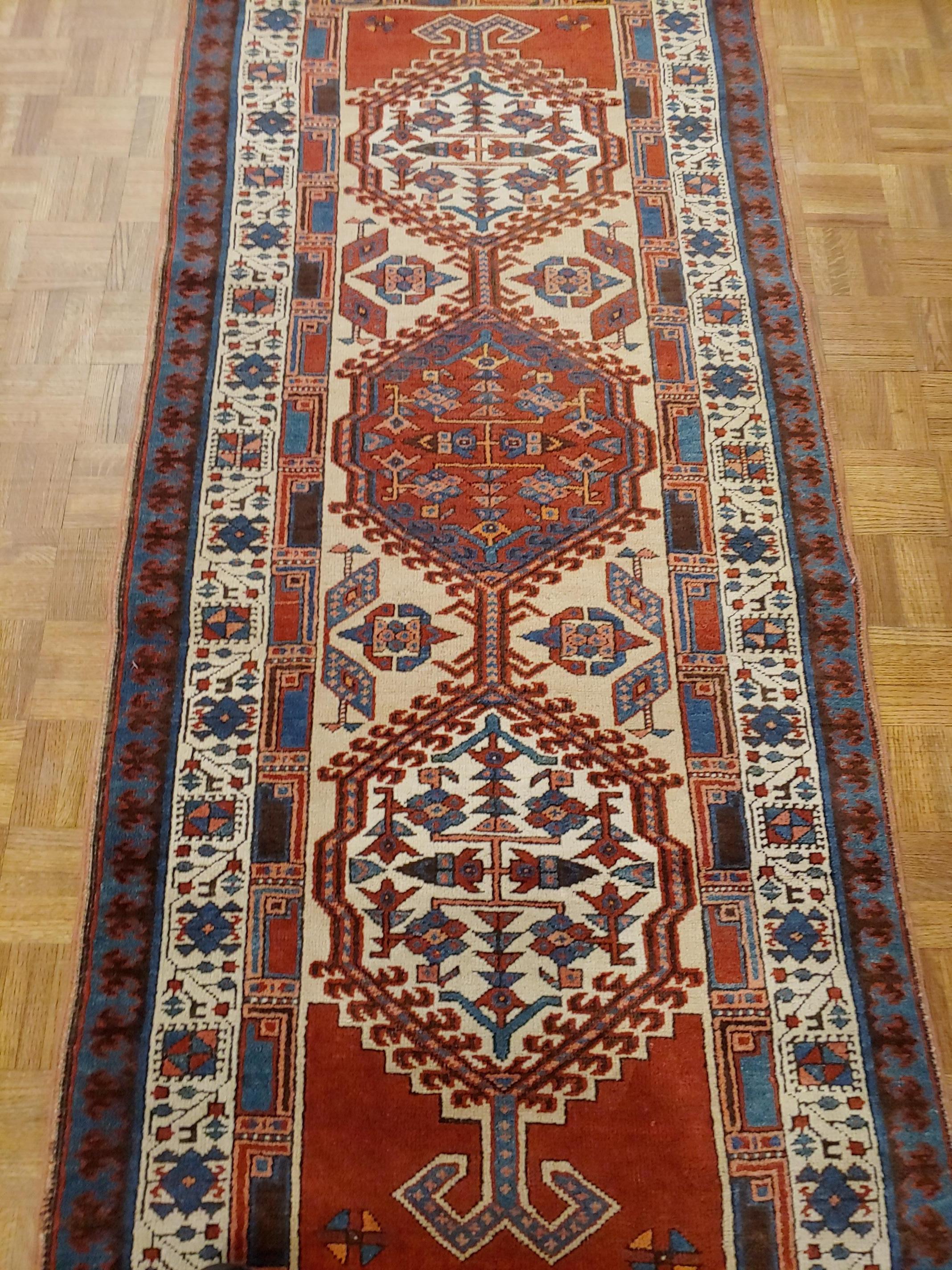 This is a striking antique Persian Serab. Serab rugs are known for their geometric design as well as the use of camel color. The typical Serab motif with the use of a cinnamon rust color is accented on the camel field. This rug is 2-10 x 7 and is