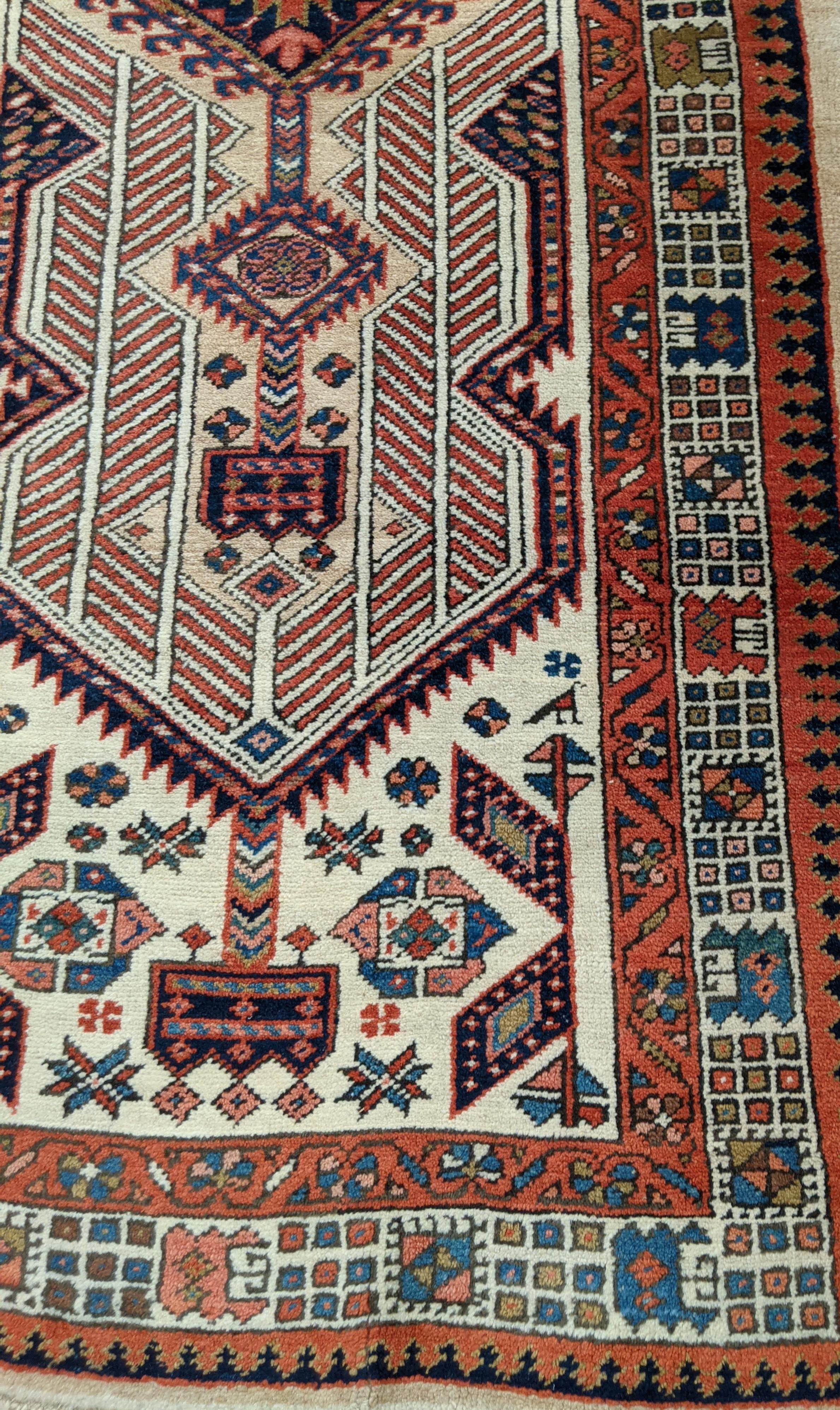 This is a striking antique Persian Serab. Serab rugs are known for their geometric design as well as the use of camel color. The typical Serab motif with the use of a cinnamon rust color is accented on the camel field. This rug is 3-4x7-11 and is