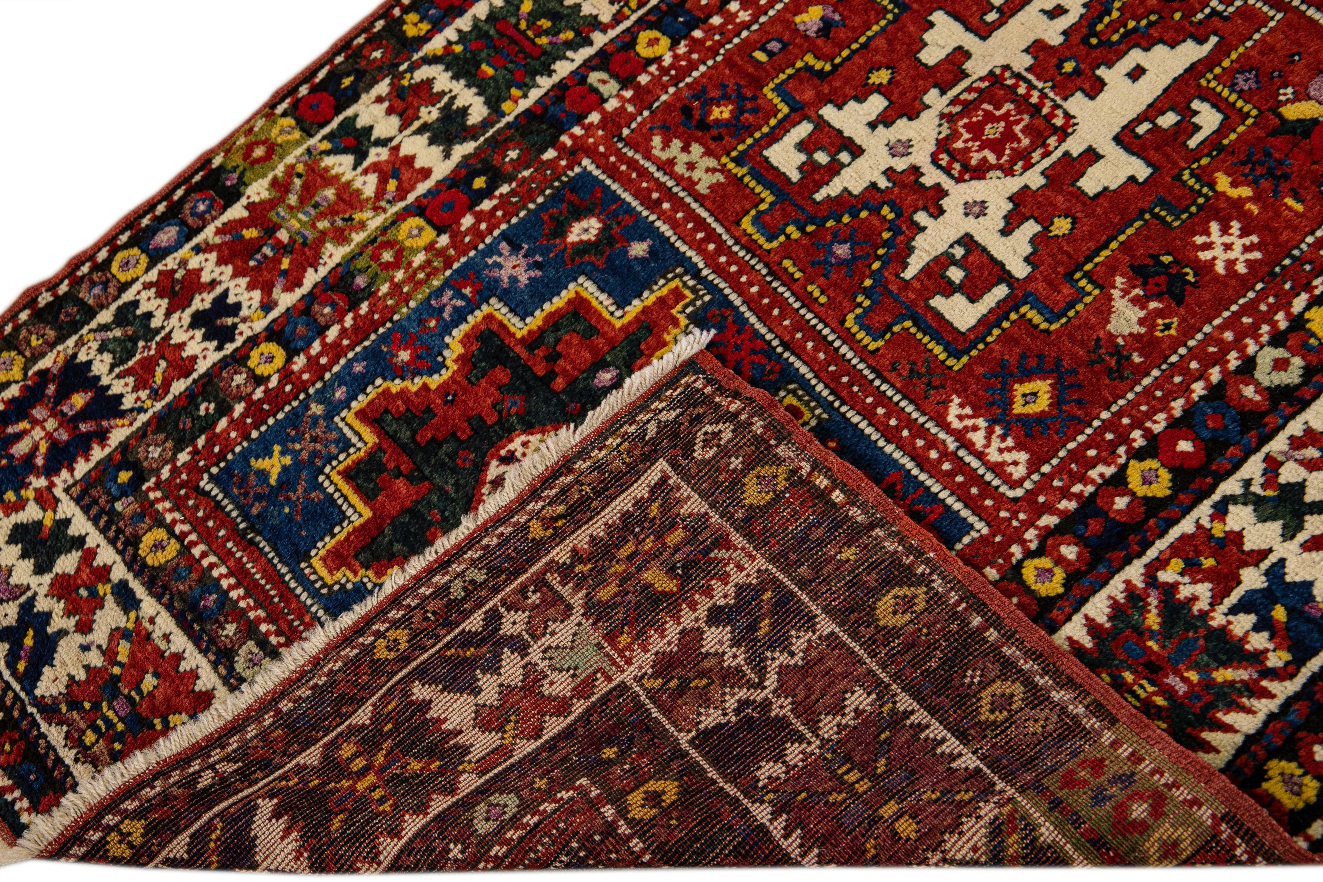 Beautiful antique Serab hand-knotted wool runner with a red field. This Persian rug has a beige frame and multicolor accents in a gorgeous all-over geometric tribal design.

This rug measures: 3'7