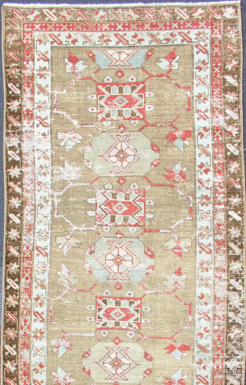 Serab antique distressed runner from Persia with geometric medallions and ornate multi-tiered border, rug R20-75, country of origin / type: Iran / Serab, circa 1910.

This antique Serab carpet from 1910s Persia features an unusual alternating shape