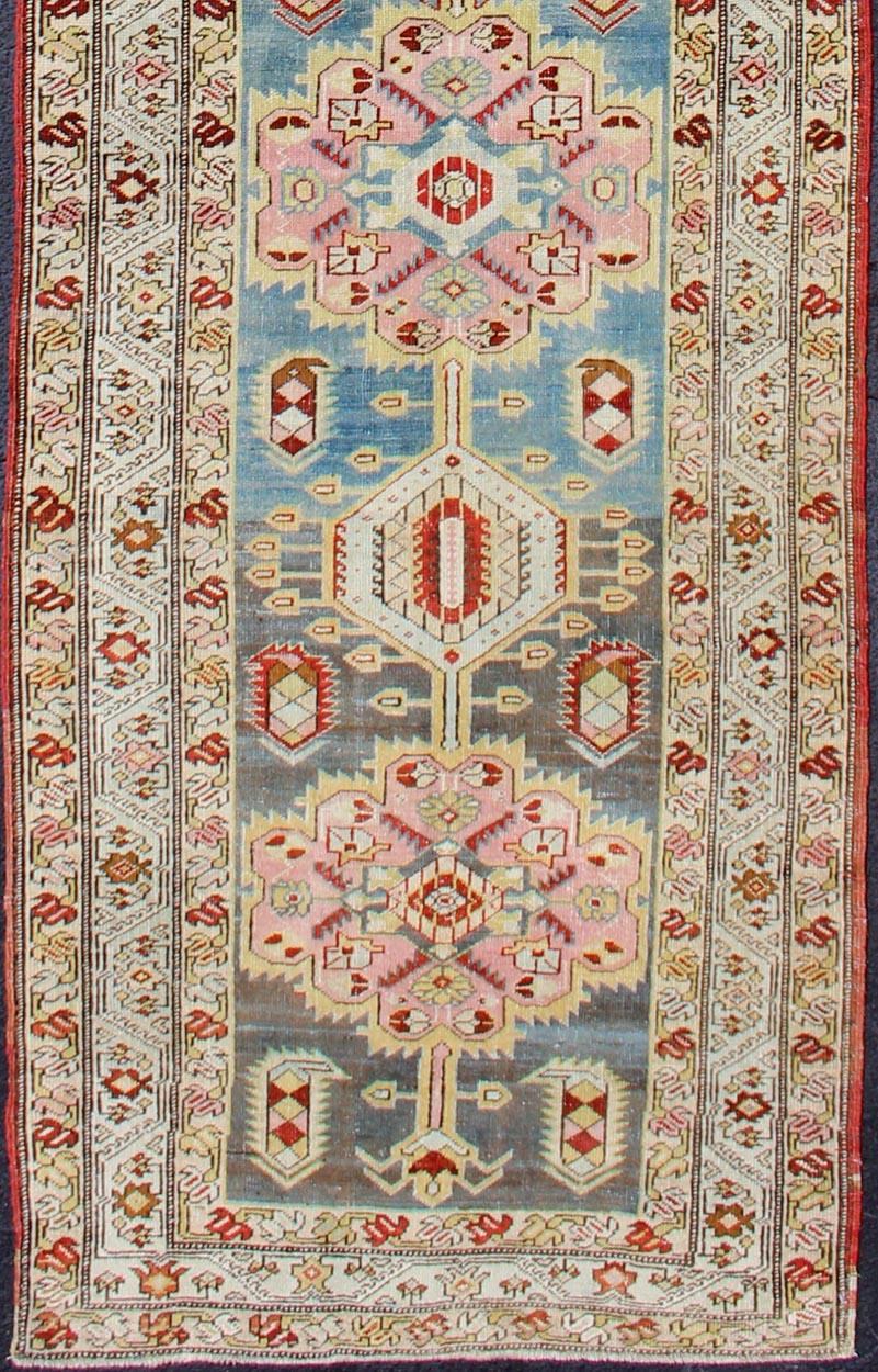 Serab antique runner from Persia with geometric medallions and ornate multi-tiered border, rug SUS-1909-423, country of origin / type: Iran / Serab, circa 1910

This antique Serab carpet from 1910s Persia features a traditional medallion design