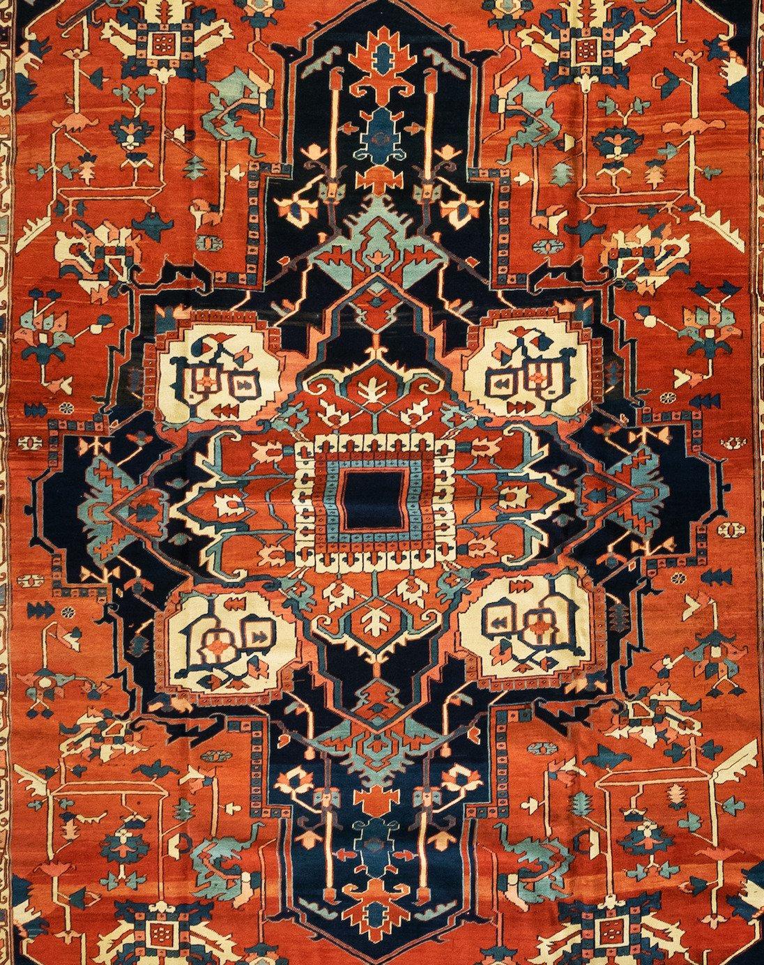 This is an exquisite hand knotted antique Persian Serapi carpet with a medallion geometric design from circa 1880-1900. This rug measures 12 x 19.6 ft. and is in pristine condition.
