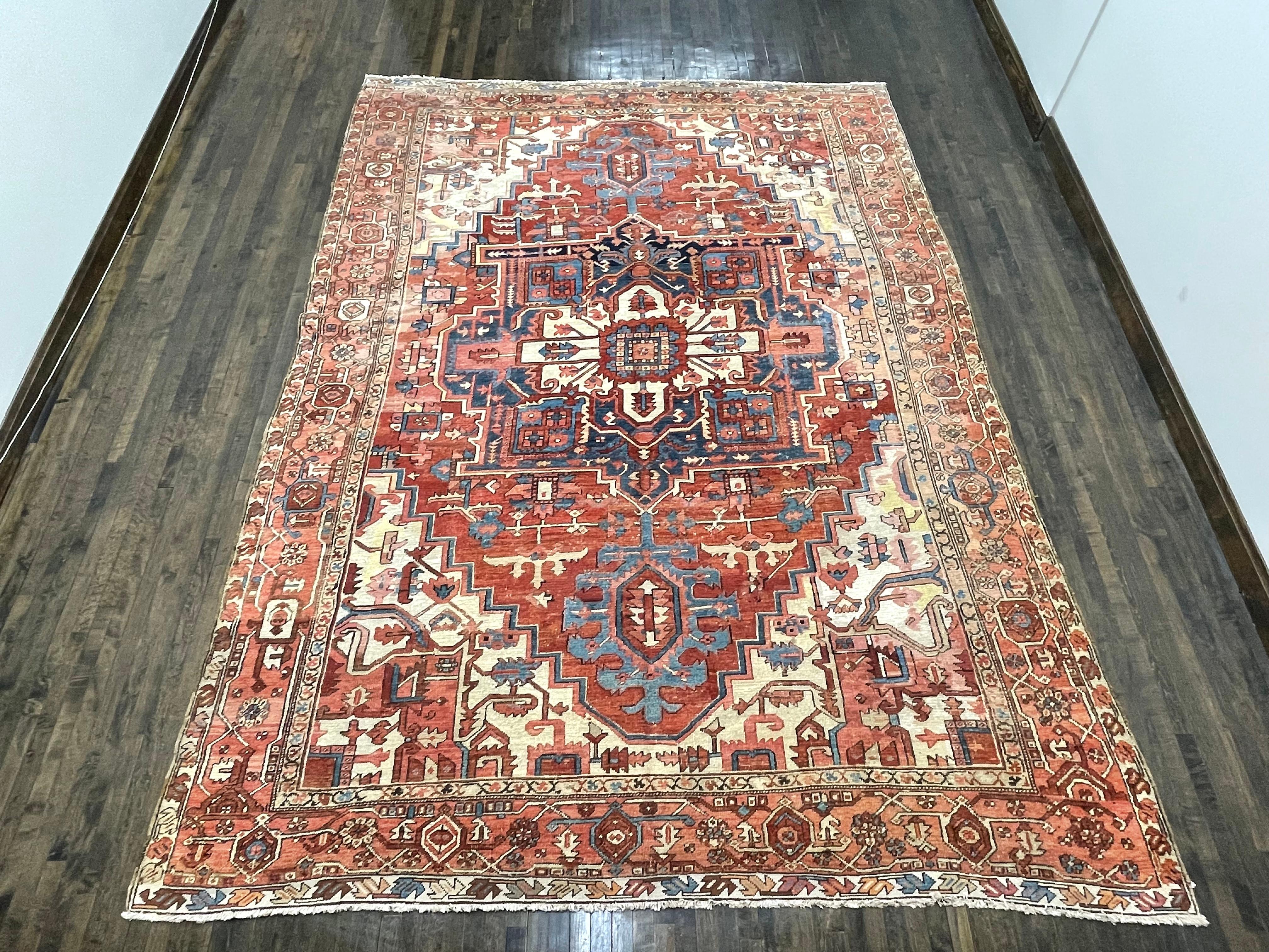 This carpet was hand woven in area know as Serapi/Heriz located in north west Iran. The rug has a huge cruciform medallion surrounded by simple angular vines and spandrels within a crab border. The salmon/rust field has a wonderful patina that age