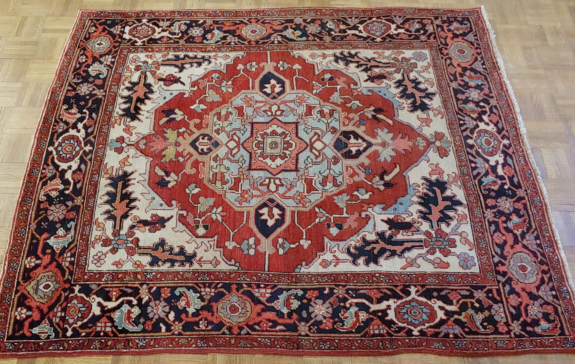 This is a rare scatter size antique Persian Serapi. These rugs also known as an antique Heriz, because they were woven in the city of Heriz before the transition to busier patterns and brighter colors. This rug has a very stately design with a