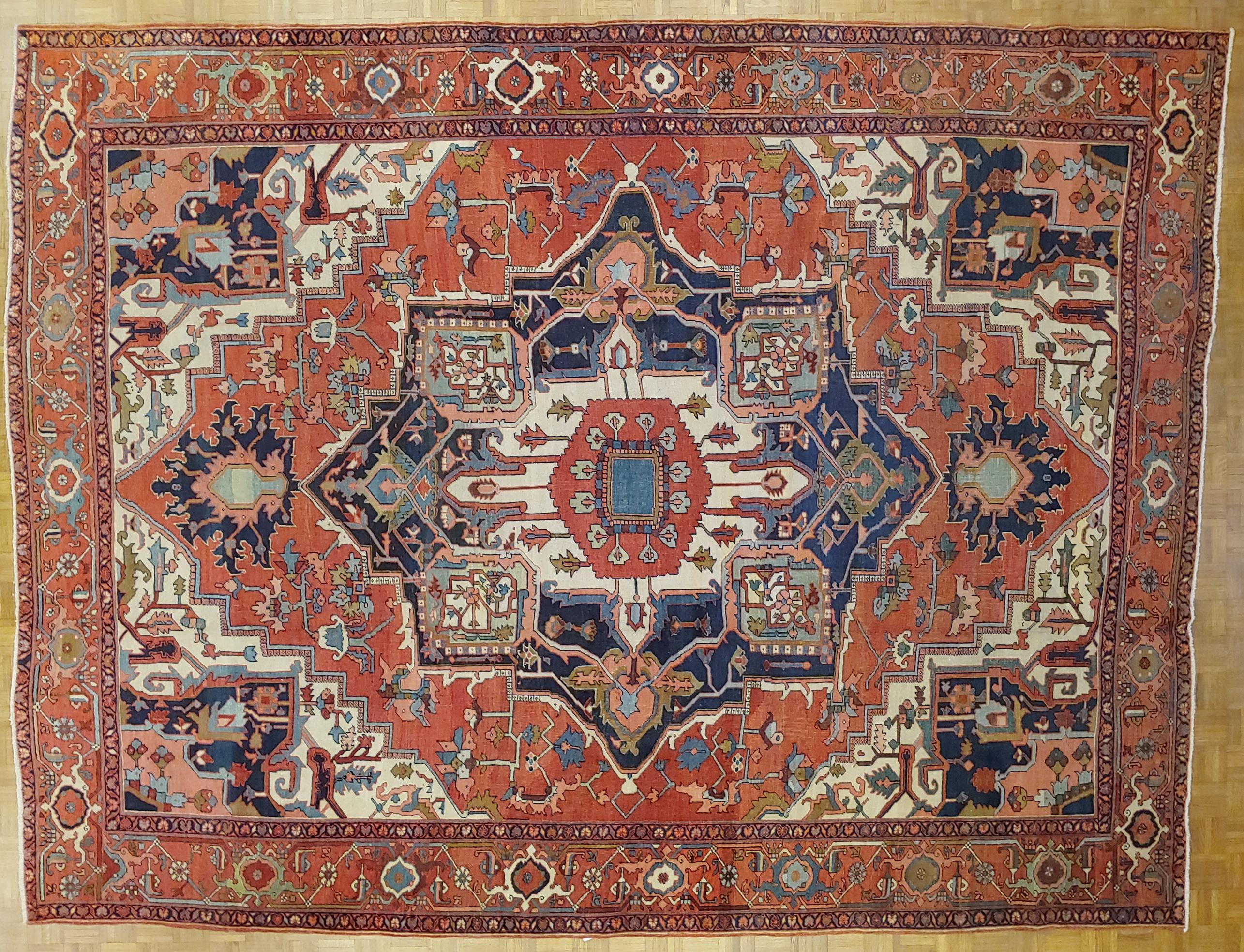 This is a great antique Persian Serapi. These rugs also known as an antique Heriz, because they were woven in the city of Heriz before the transition to busier patterns and brighter colors. This rug has a very stately design with a characteristic