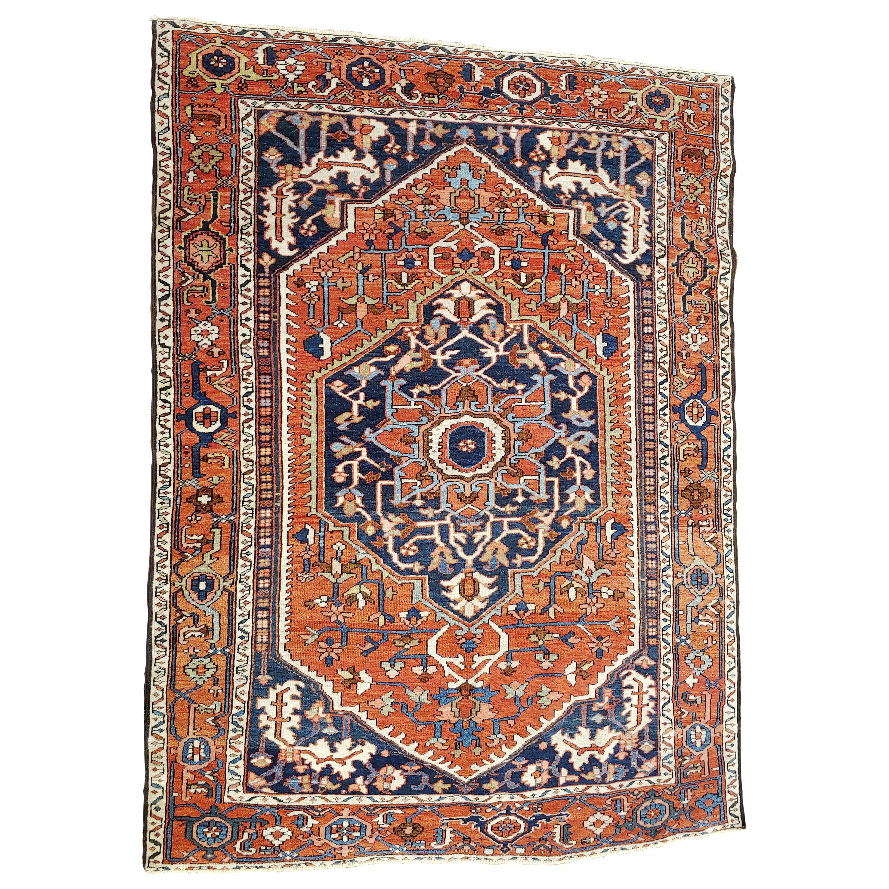 This is a rare scatter size antique Persian Serapi. These rugs also known as an antique Heriz, because they were woven in the city of Heriz before the transition to busier patterns and brighter colors. This rug has a very stately design with a