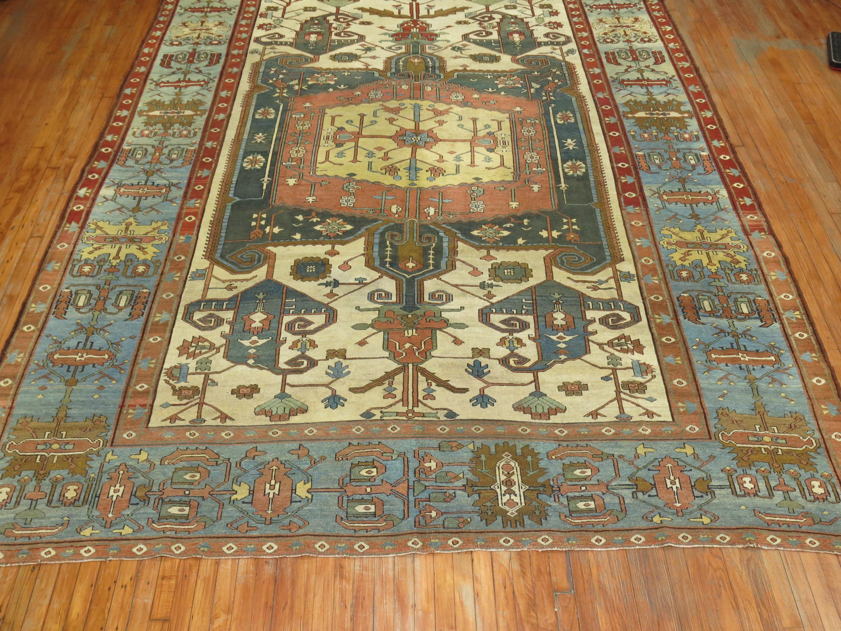 An early 20th century dramatic Masculine and colorful Persian Heriz Serapi carpet.

Heriz carpets are beloved for their versatility. Their geometry complements modern furnishings and their warm colors and artistic depth enhances antiques of all