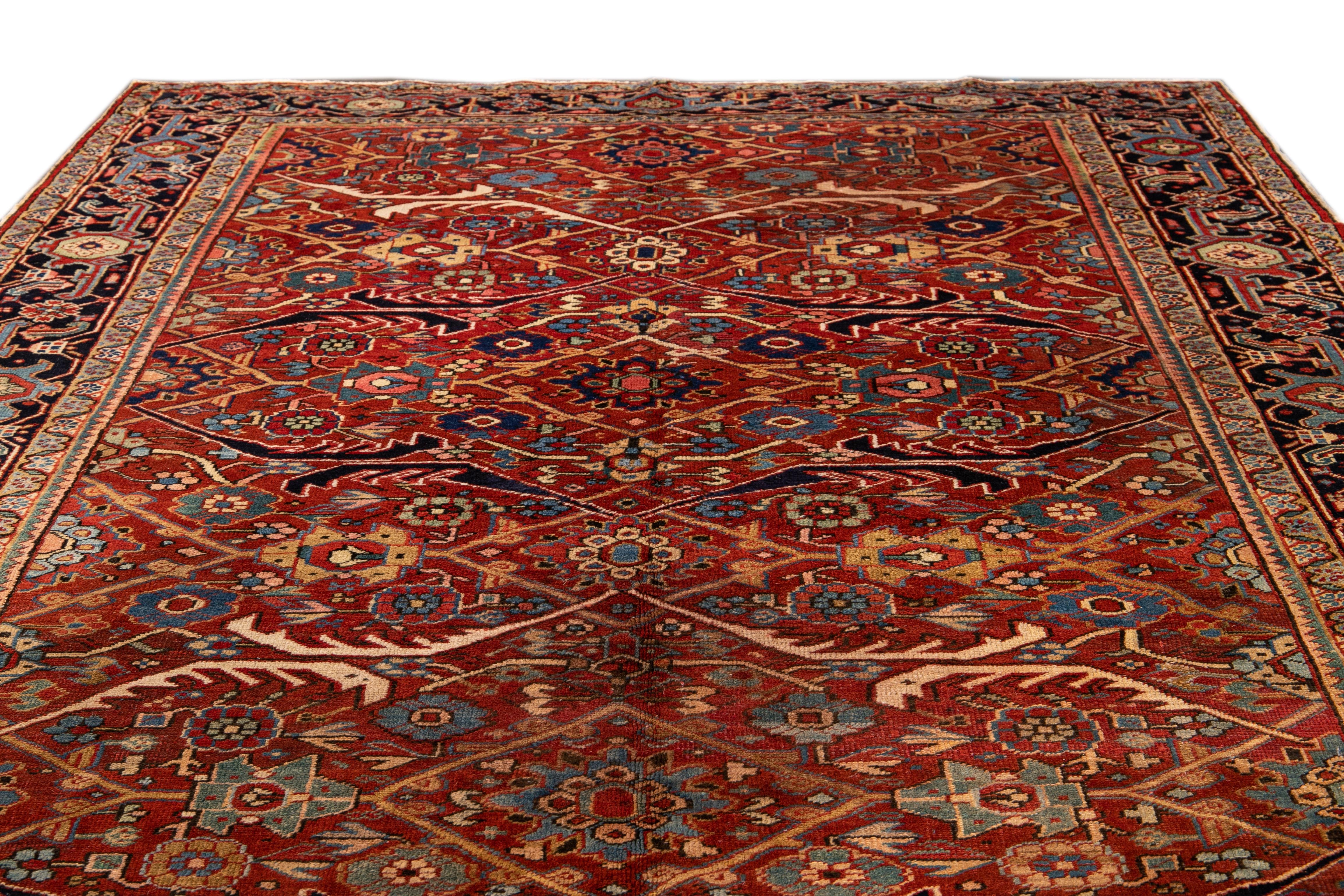 Beautiful antique Persian Serapi hand-knotted wool rug with a red field. This Serapi rug has a navy-blue frame and multi-color accents in an all-over gorgeous geometric medallion floral design.

This rug measures: 7'9