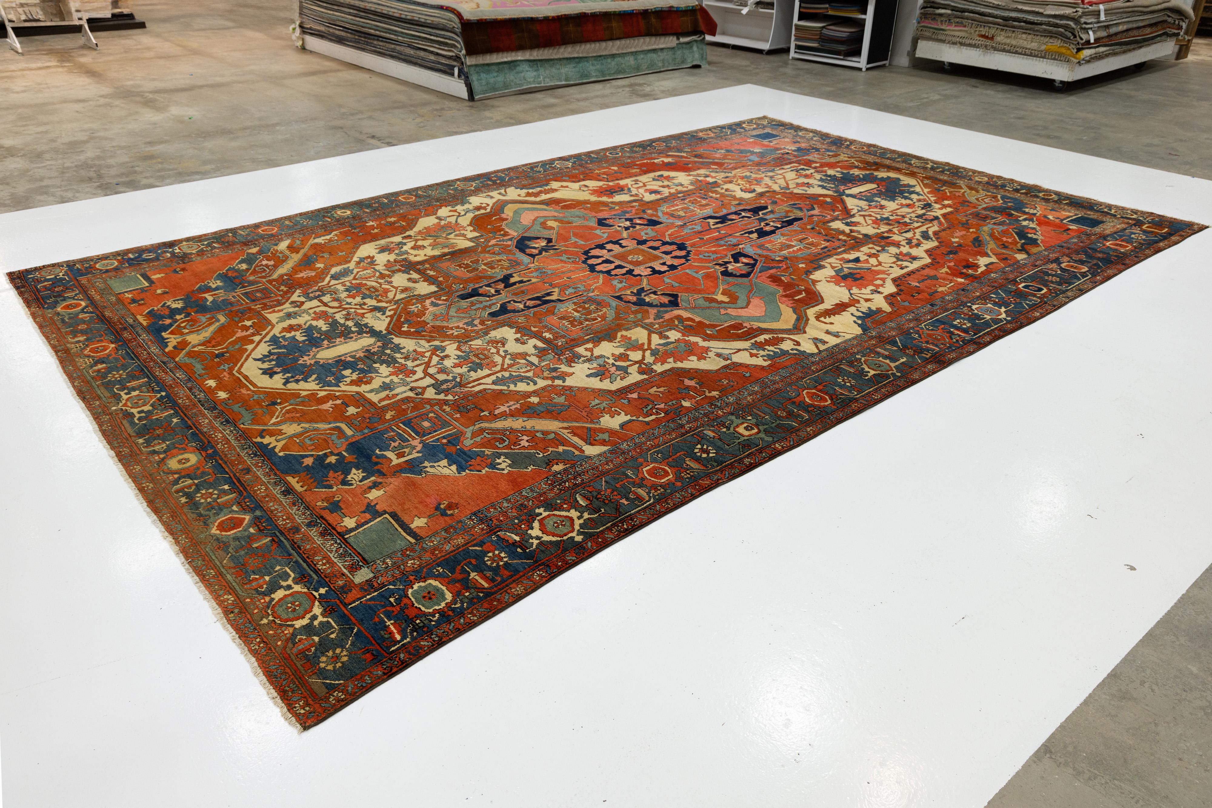 Antique Persian Serapi Red Wool Rug Featuring a Medallion Design (Persisch) im Angebot