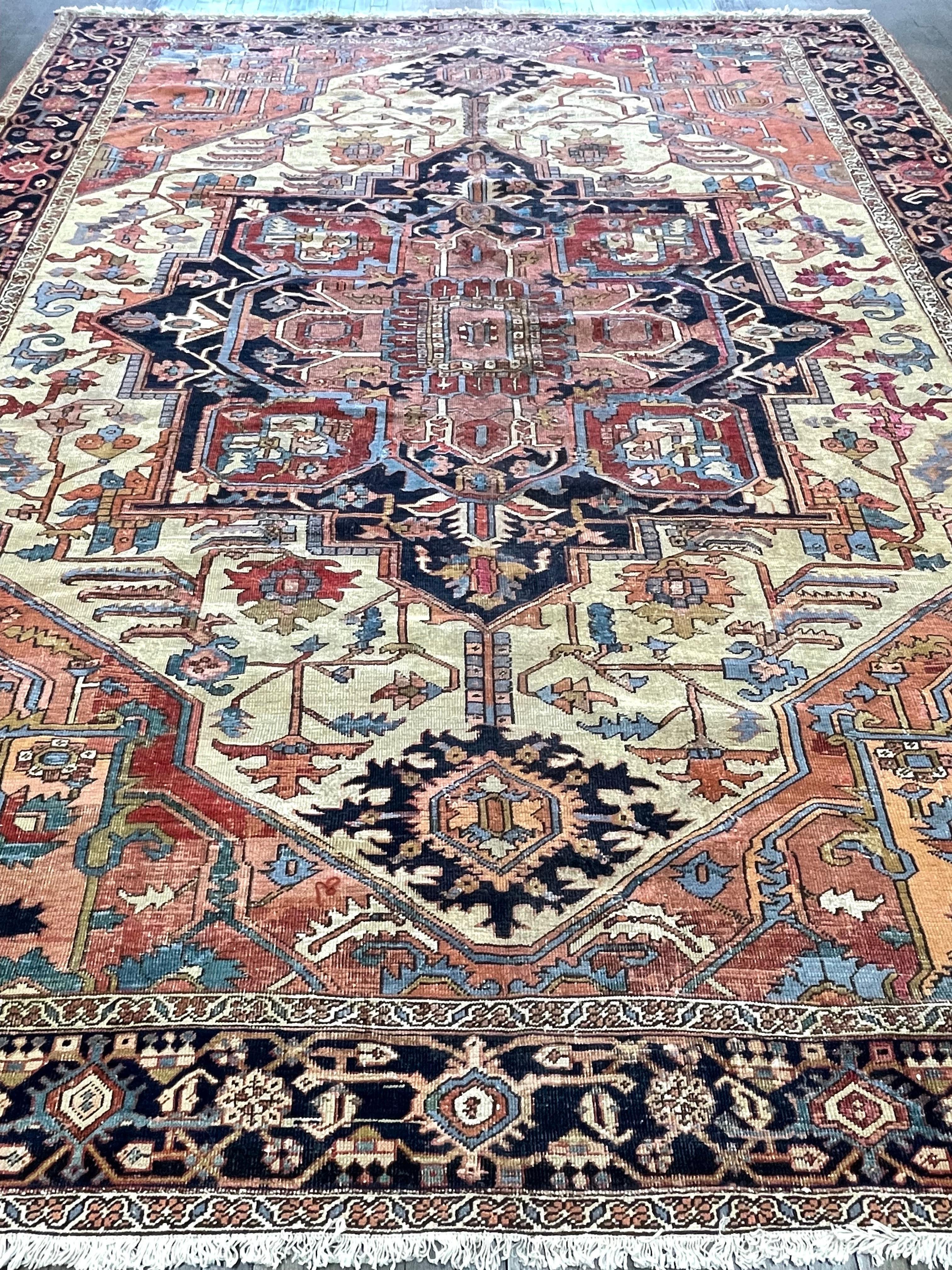 The all -important ivory field much sought after by collectors, this carpet was handmade in Serapi area by Heriz town. The colors within the details of this majestic Serapi are still clear and fresh despite being woven in turn of the century. The