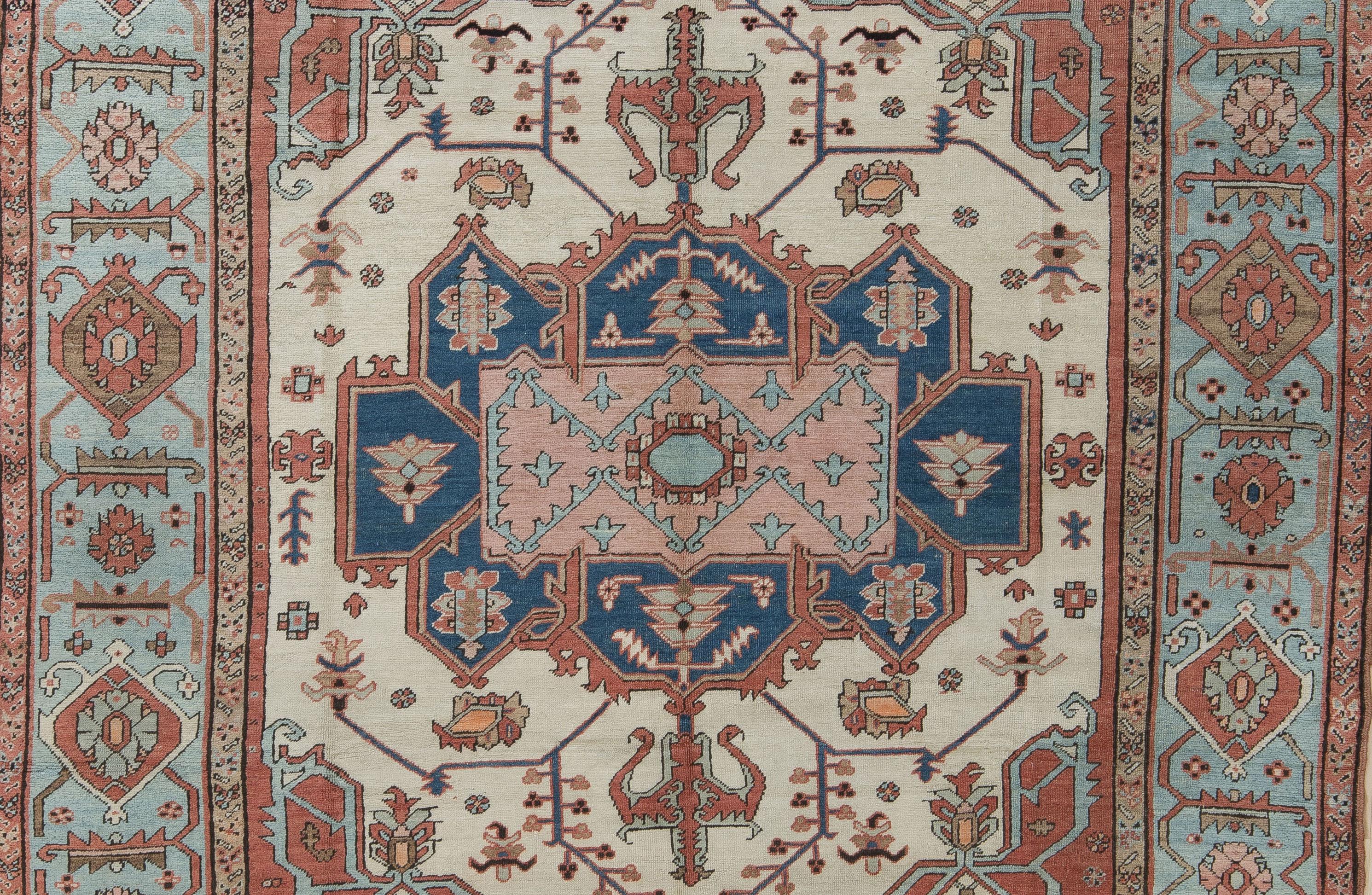 A wonderful example of a late 19th Century Persian Serapi. A true, fine weave with an even low wool pile. Soft vegetable dyes and an unusual French blue border. An open tribal design and demonstrates beautiful variation in color, referencing the
