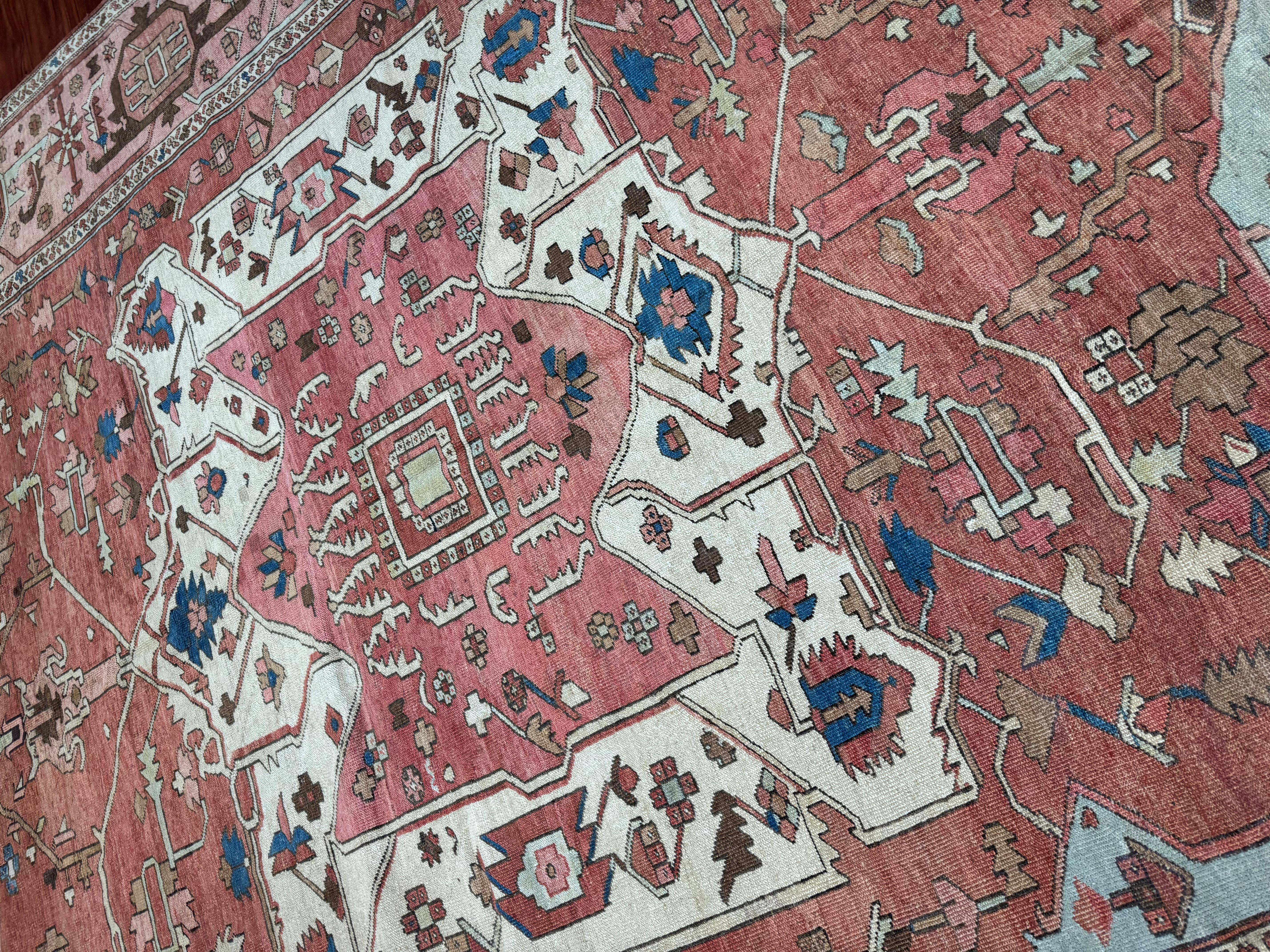 A truly stunning antique Persian Serapi rug, originating from Iran in the late 19th century, this exceptional piece is a rare testament to Persian craftsmanship and artistry. Renowned for their elegant yet bold geometric designs, Serapi rugs are