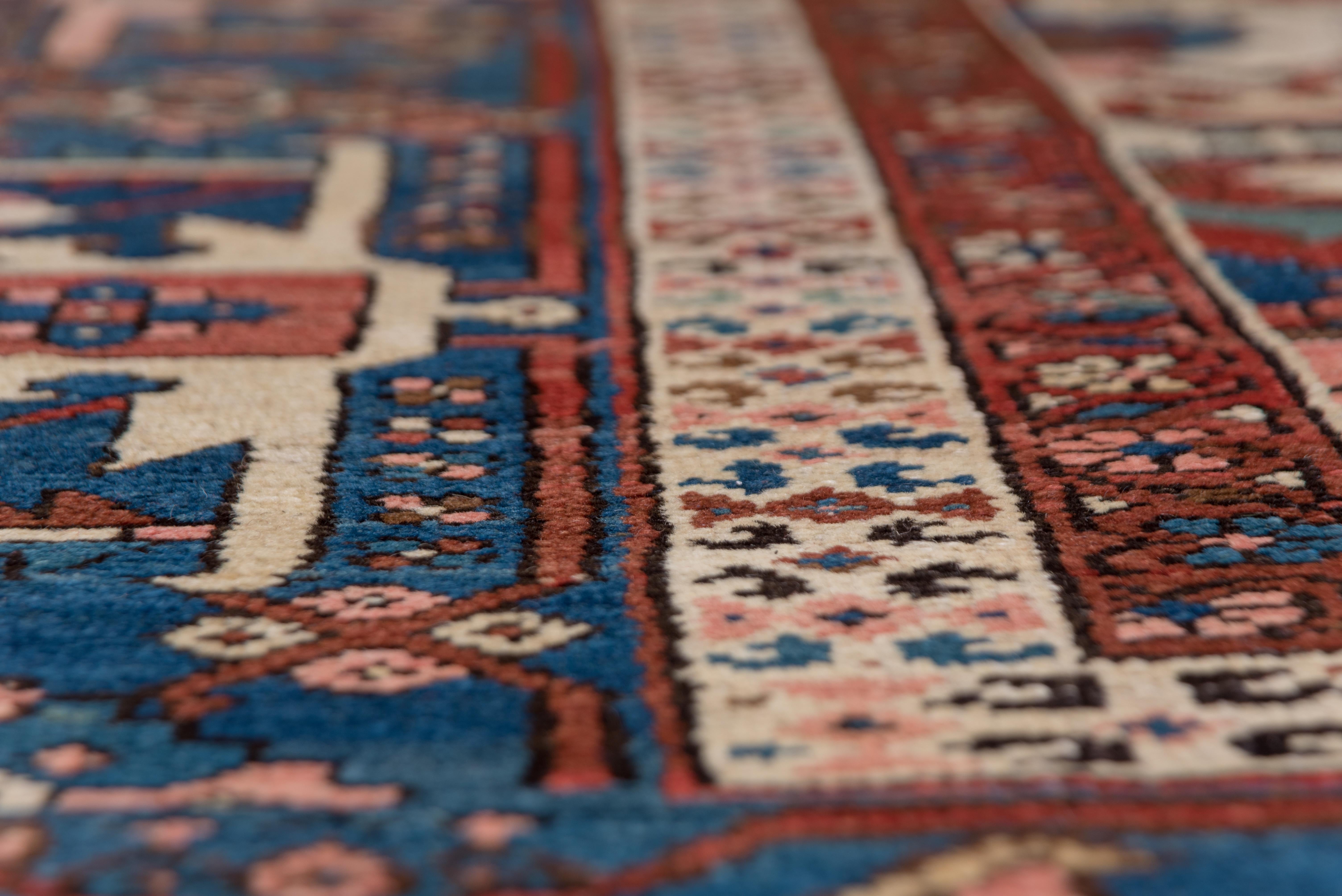Hand-Knotted Antique Persian Serapi Rug, Rust Field, Blue Borders, Pink and Green Accents For Sale