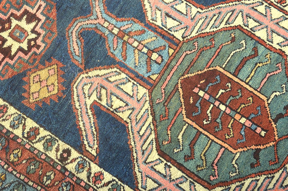 This Serapi rug is an excellent representation of why they are some of the most famous rugs from Iran, because of their very unique and distinguishable style. This rug features a strong geometric pattern featuring over-sized shapes and medallions