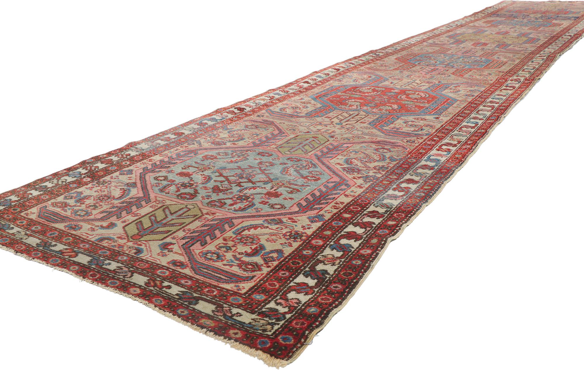 78282 Antique Persian Serapi runner 3'02 x 18'04. Full of tiny details and a bold expressive design combined with tribal style, this hand-knotted wool antique Persian Serapi runner is a captivating vision of woven beauty. The abrashed field features
