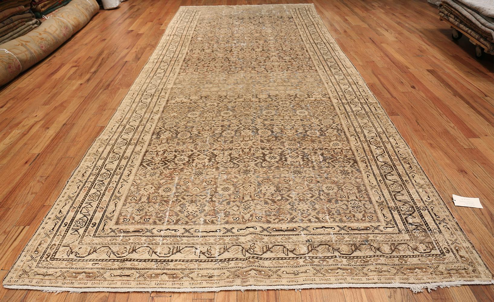 Antique Persian Shabby Chic Malayer Wide Hallway Gallery Rug, Country of Origin: Persia, Circa Date: Early 20th century (Around the 1910s) Size: 6 ft 8 in x 16 ft 4 in (2.03 m x 4.98 m)

This shabby chic rug, a beautiful antique Persian Malayer wide