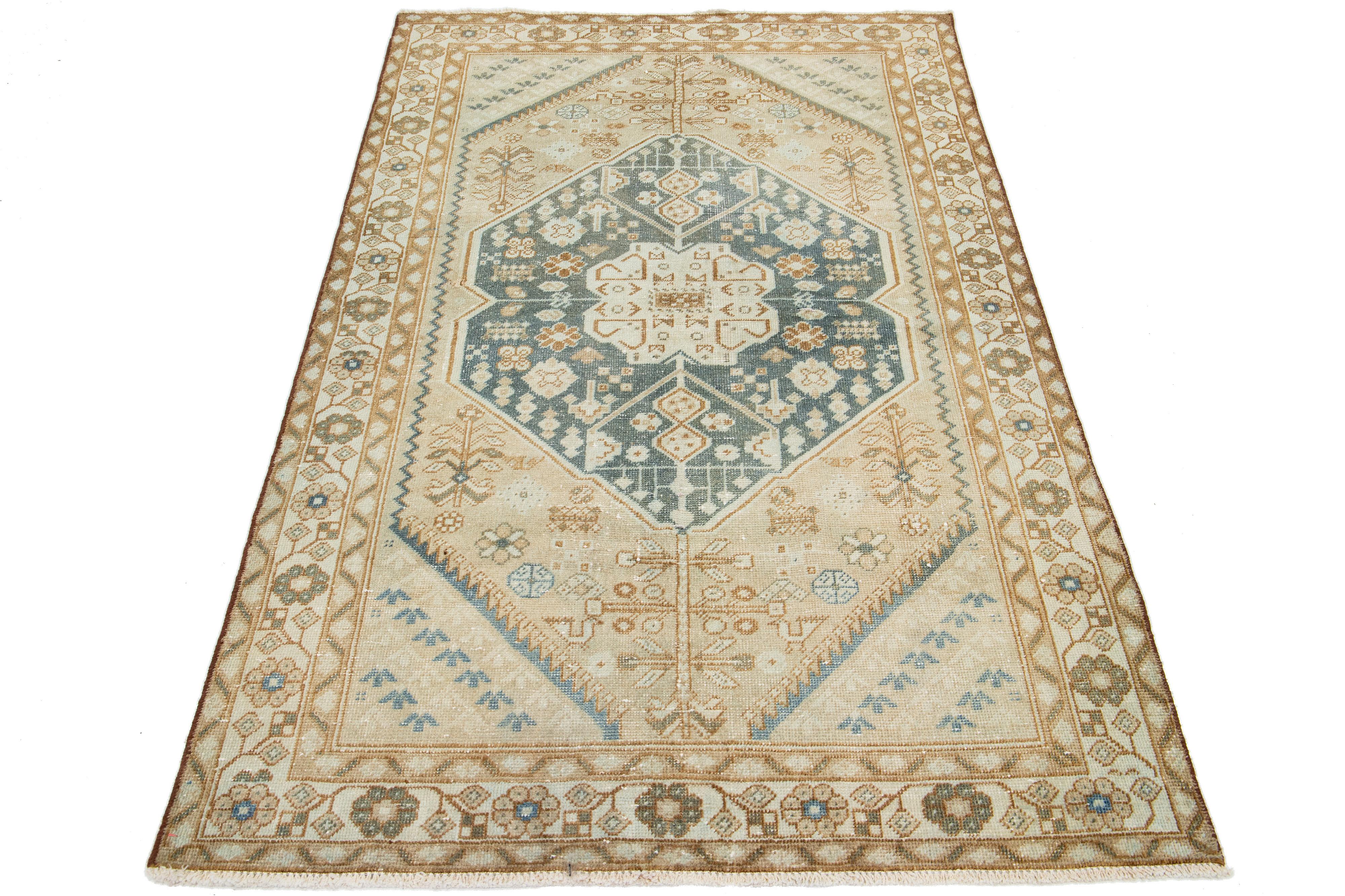 This wool rug showcases a tribal pattern with brown and blue accents on a beige background inspired by Persian Shiraz designs.

This rug measures 4'2