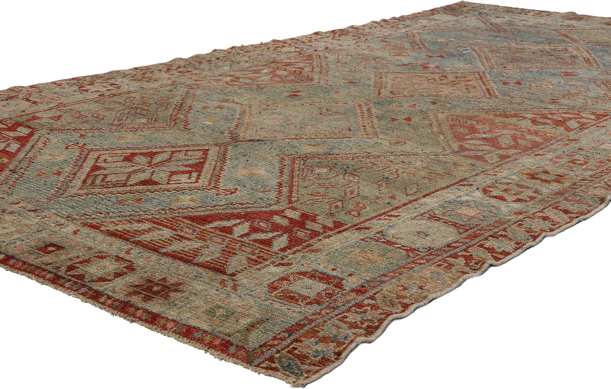 52455 Antique Persian Shiraz Rug, 04’06 x 08’05. In the captivating realm of nomadic charm, behold this hand-knotted wool antique Persian Shiraz rug, a woven masterpiece that whispers tales of a bygone era. A subtle tribal style weaves its magic,