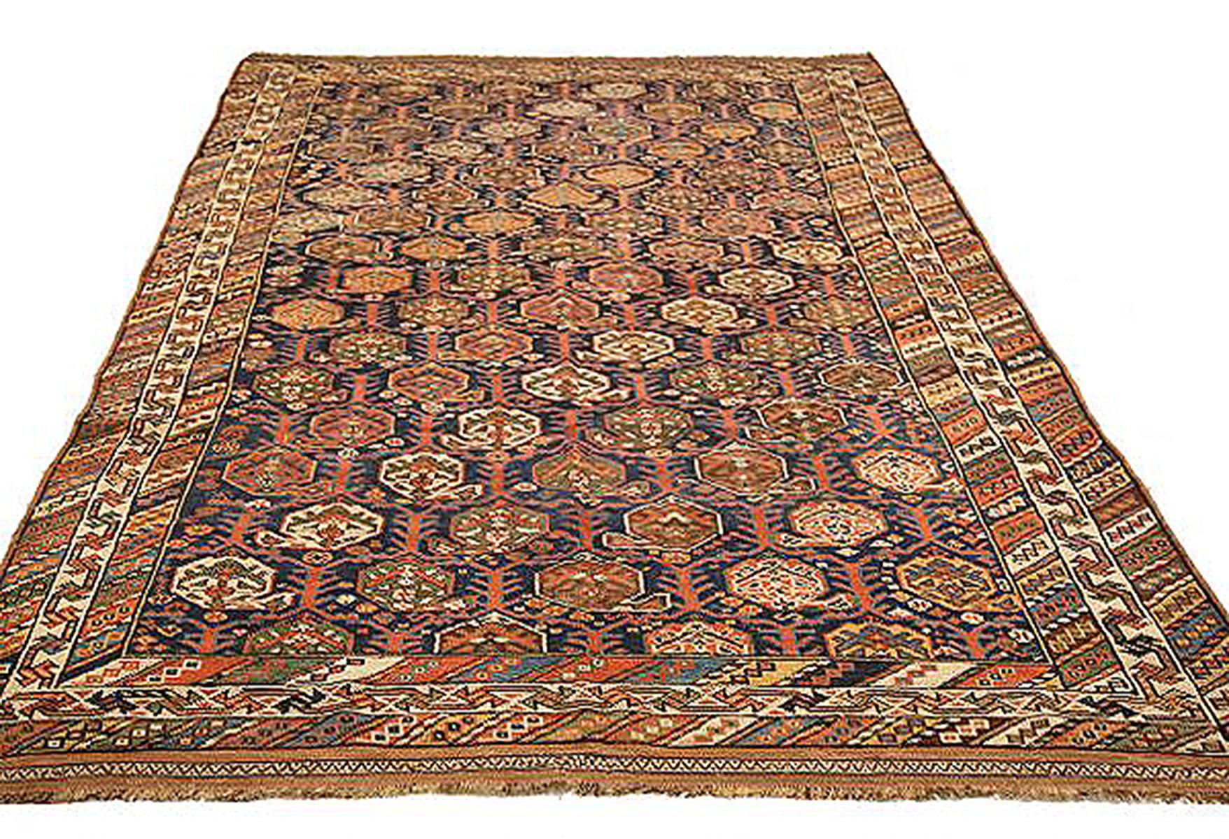 Antique Persian rug handwoven from the finest sheep’s wool and colored with all-natural vegetable dyes that are safe for humans and pets. It’s a traditional Shiraz design featuring green and brown floral medallions over a mix of black and navy