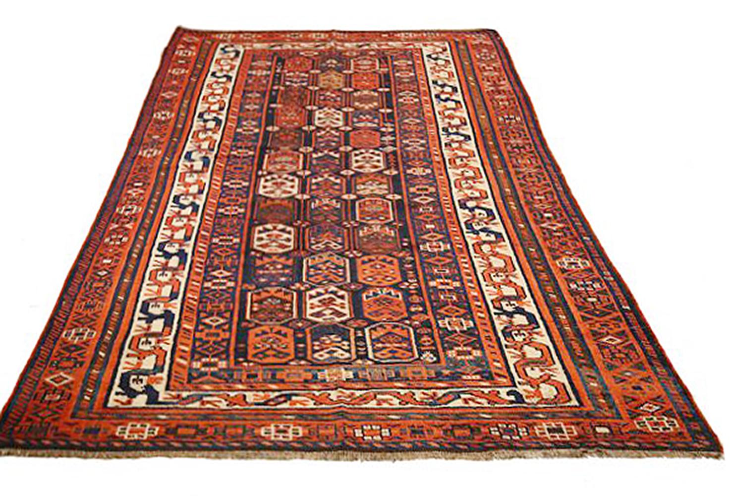 Antique Persian rug handwoven from the finest sheep’s wool and colored with all-natural vegetable dyes that are safe for humans and pets. It’s a traditional Shiraz design featuring ivory and navy geometric details over a mix of rust and navy field.