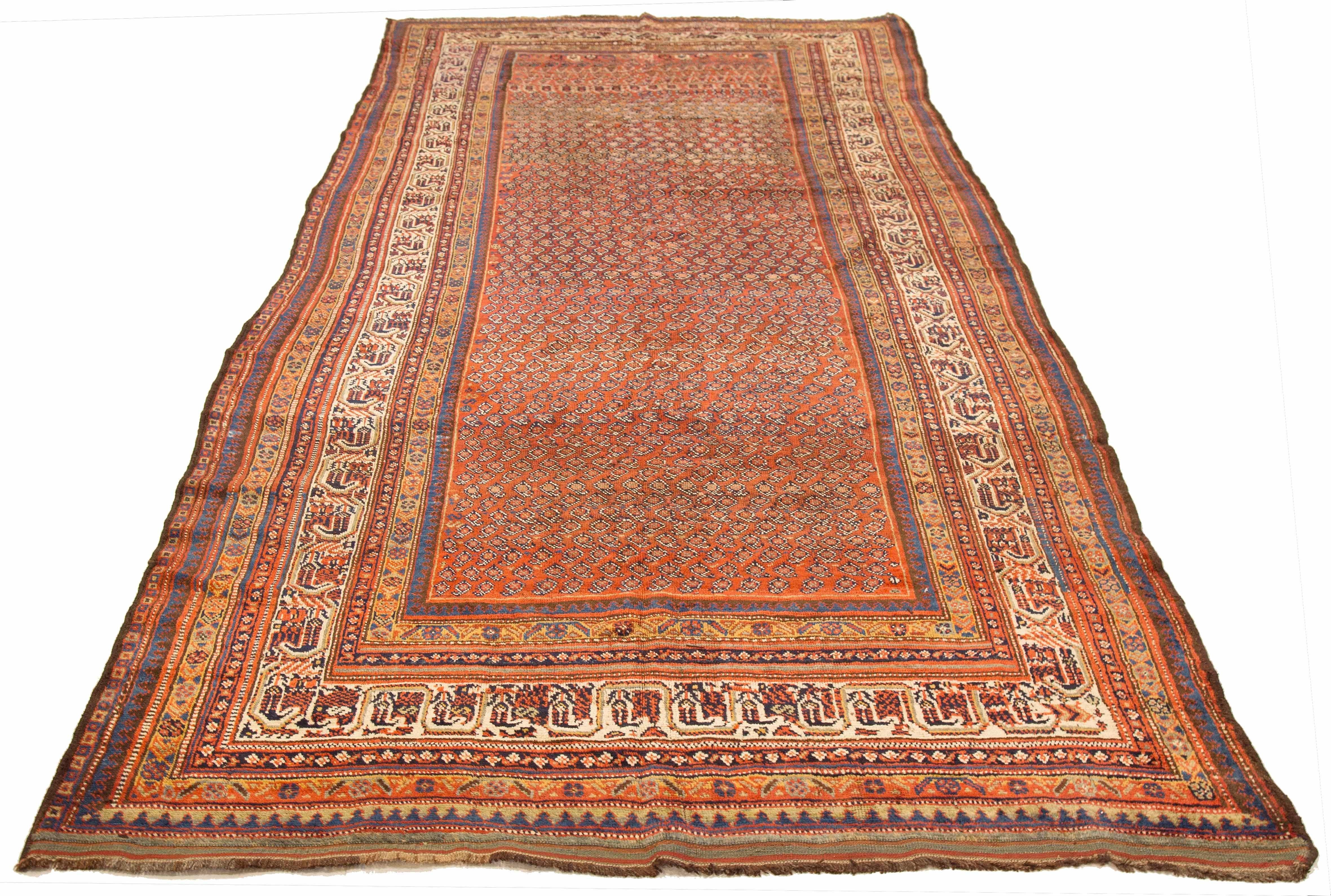 Antique Persian rug handwoven from the finest sheep’s wool and colored with all-natural vegetable dyes that are safe for humans and pets. It’s a traditional Shiraz design featuring black and red tribal details over a navy field. It’s a lovely piece