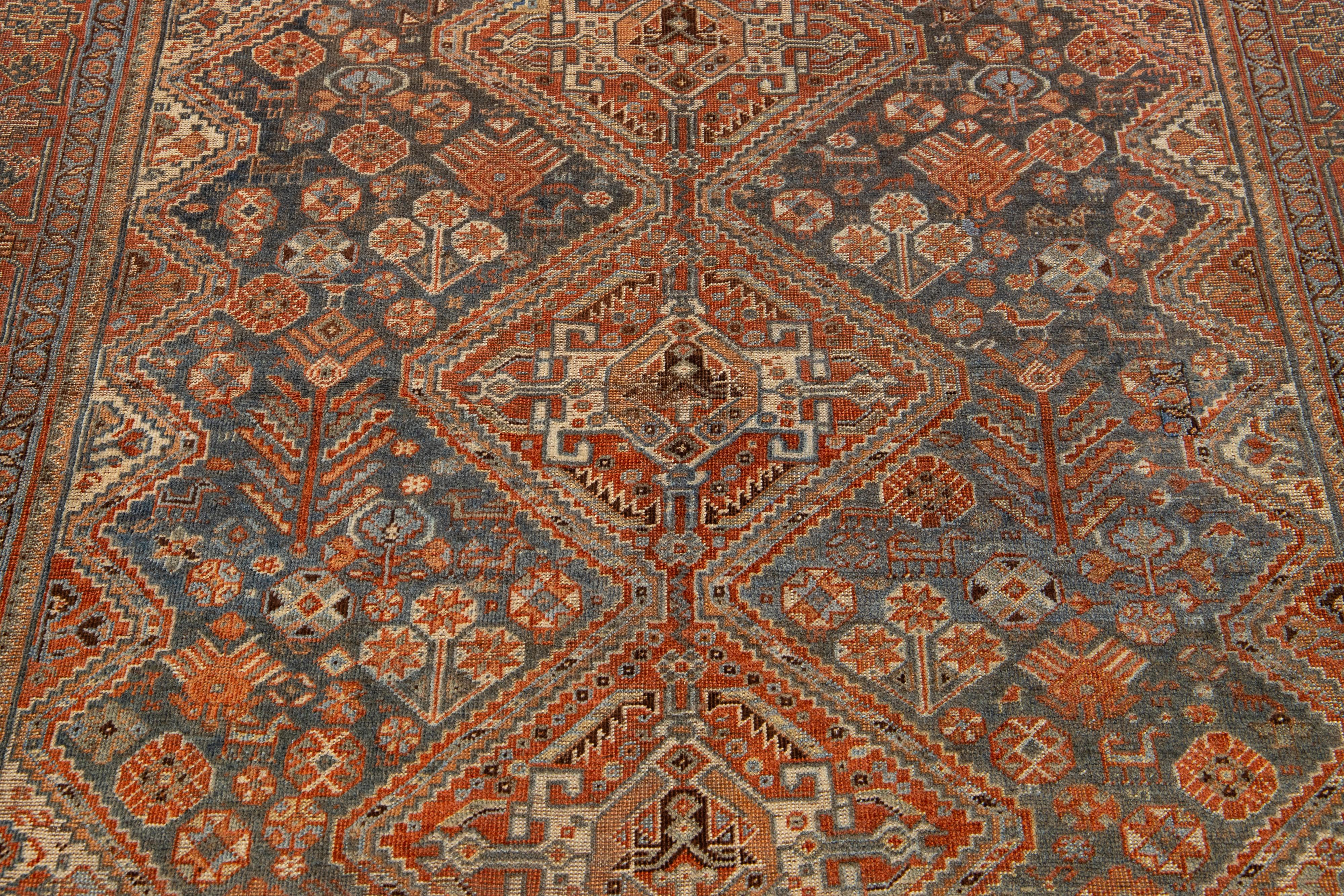 20th Century Antique Persian Shiraz Rust & Blue Wool Rug With Allover Design For Sale