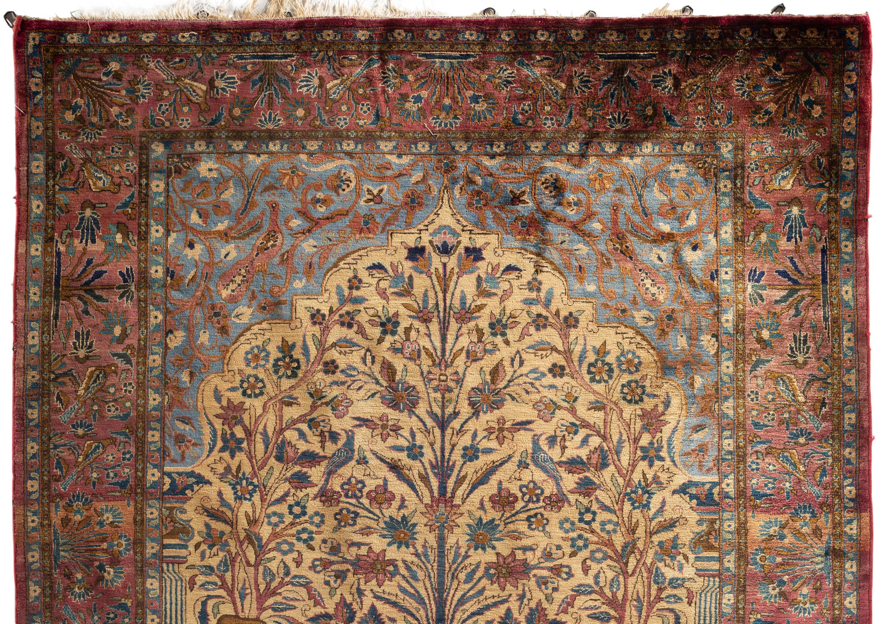Antique Persian Silk Kashan, circa 1900. Finely woven in luxurious silk with the main ivory field having wonderfully detailed floral and plant design in a range of soft gentle colors, interspersed with animals and birds to create a tranquil scene