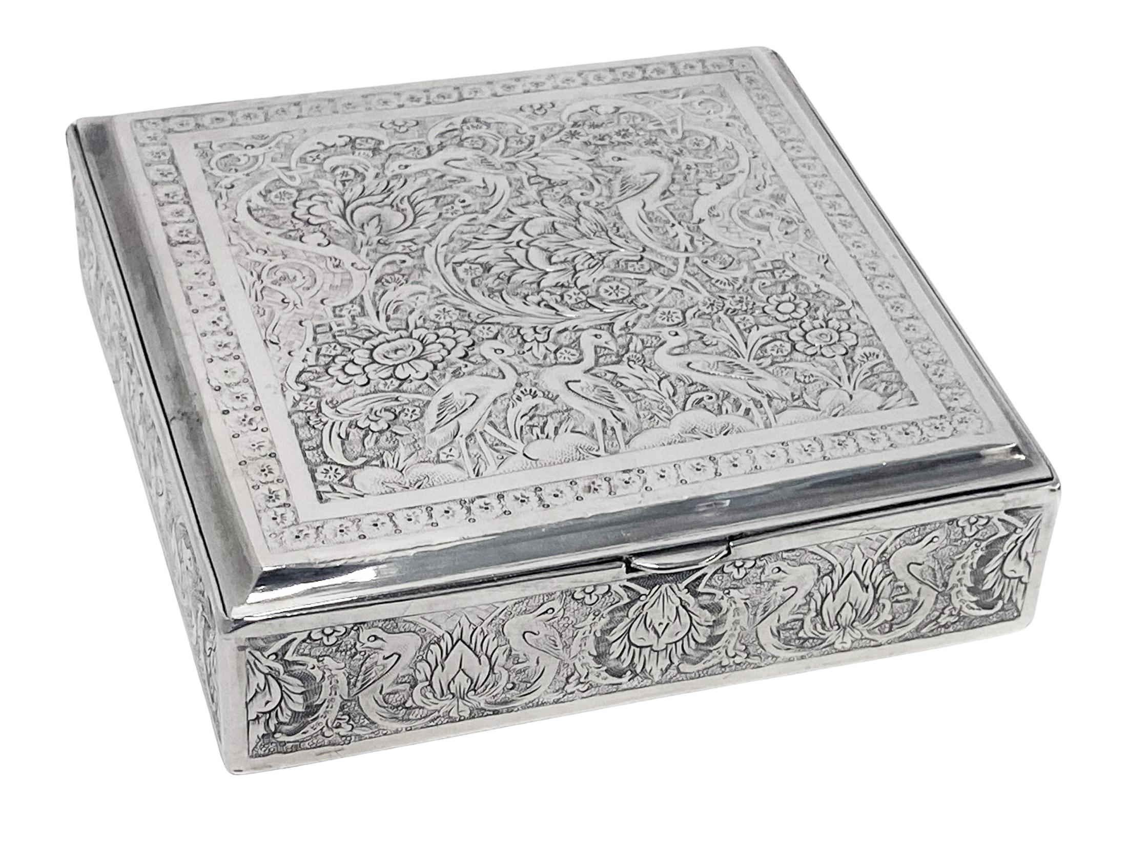 Antique Persian Silver Box C.1920. The case beautifully chased, engraved and decorated with birds, animals and foliage. Persian marks to interior. Measures: 3.40 inches square x 0.90 inches height. Original lightly gilded interior. Weight: 203