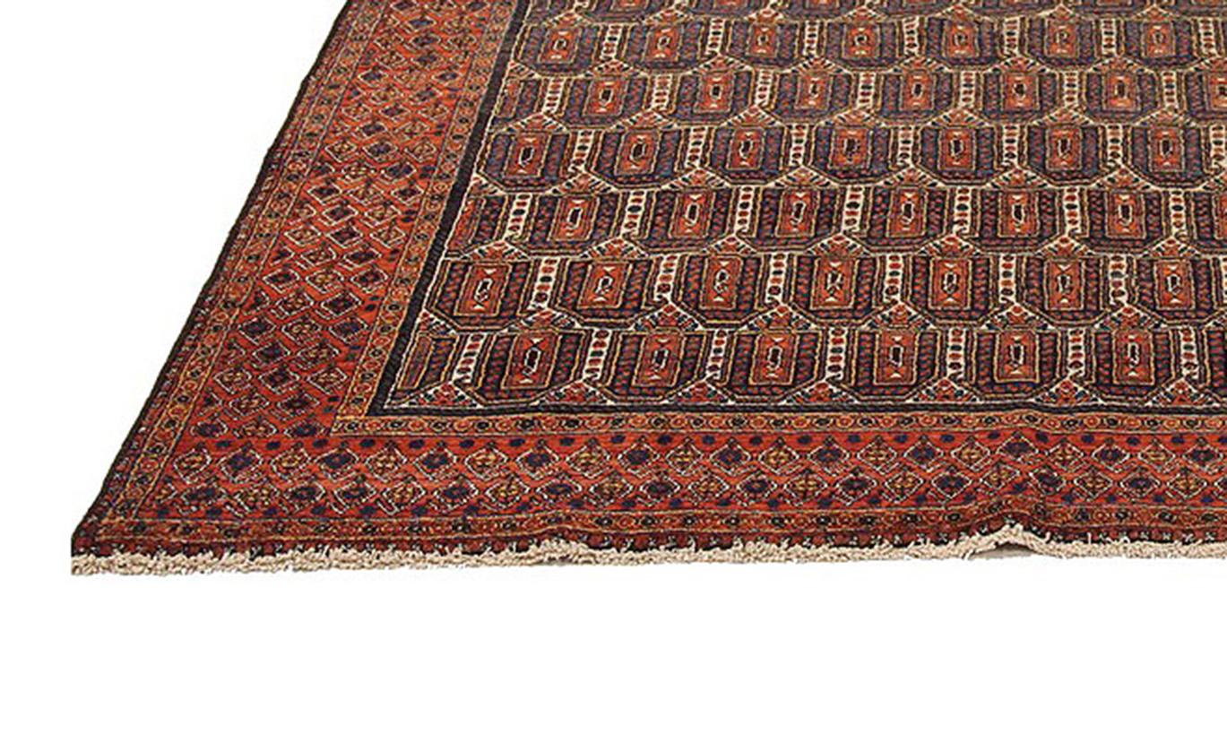 Antique Persian Sirjan rug handwoven from the finest sheep’s wool and colored with all-natural vegetable dyes that are safe for humans and pets. It’s a traditional Sirjan design featuring geometric all-over details in navy blue, white over a reddish