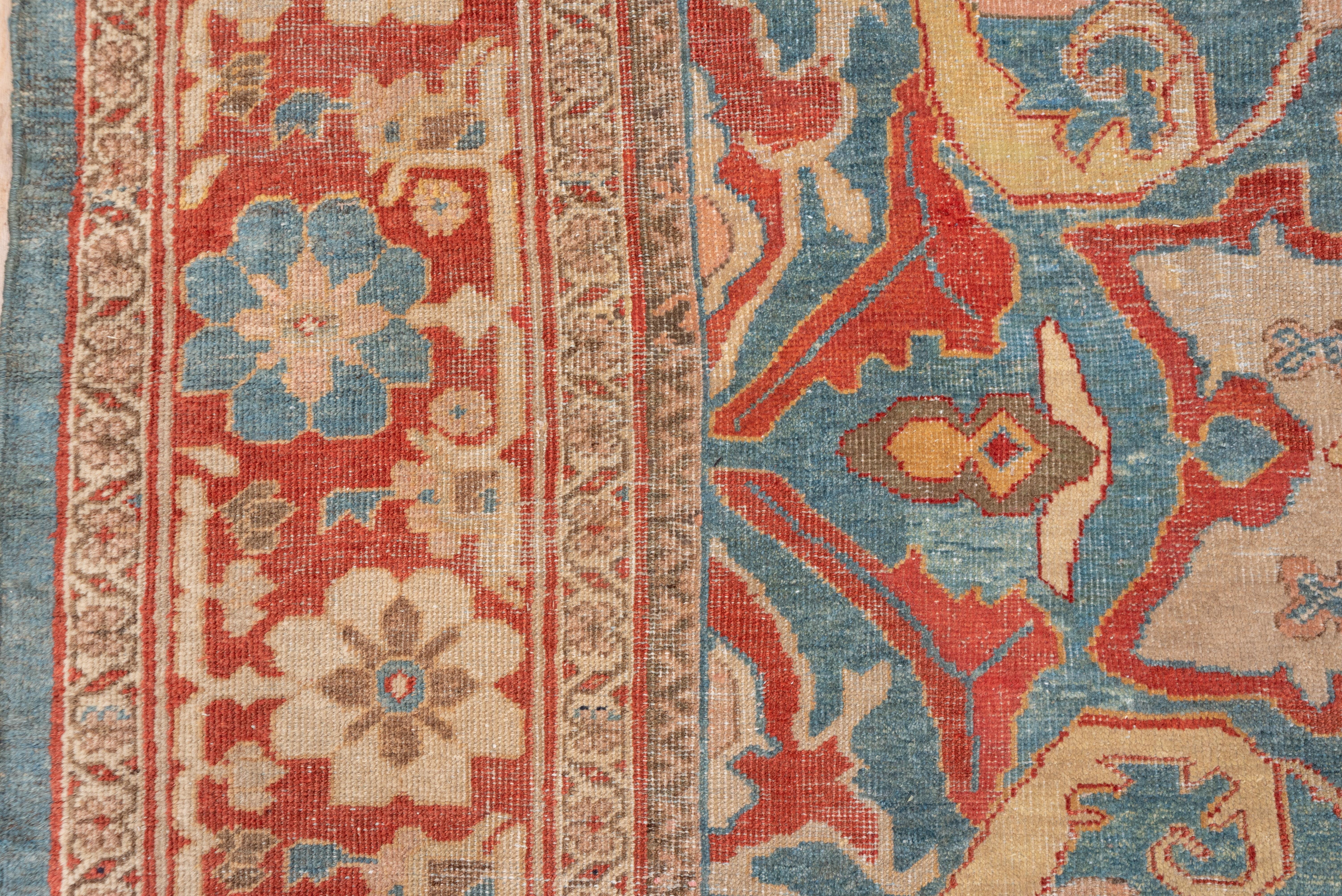 The rare sky blue field of this west Persian rustic medium-weave piece shows two large ivory stars, four large petal rust palmettes, vertical slender cartouches and bold lancet leaves. Rust border of lobed lollipop flowers. Good condition for the