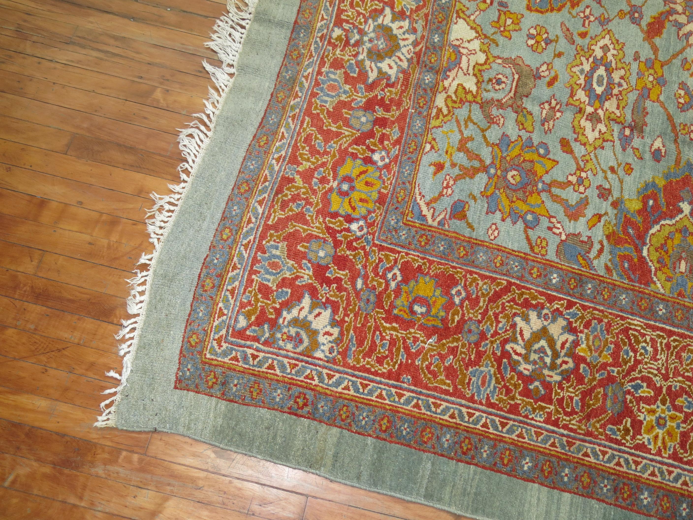A connoisseur caliber early 20th century powder blue Persian Sultanabad carpet.

Woven in a series of villages in Western Central Iran, Sultanabad carpets employ over-scale, spacious all-over patterns that are highly prized for their versatility.